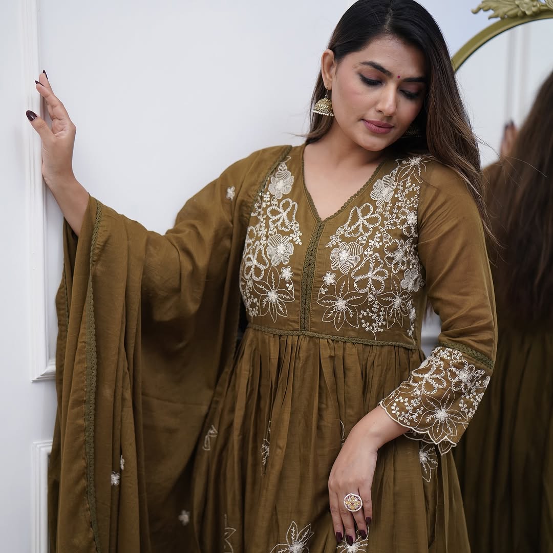 Woman posing elegantly in the TRENDBUY Sapna olive green gown with pant and dupatta, highlighting the full ensemble and intricate details.