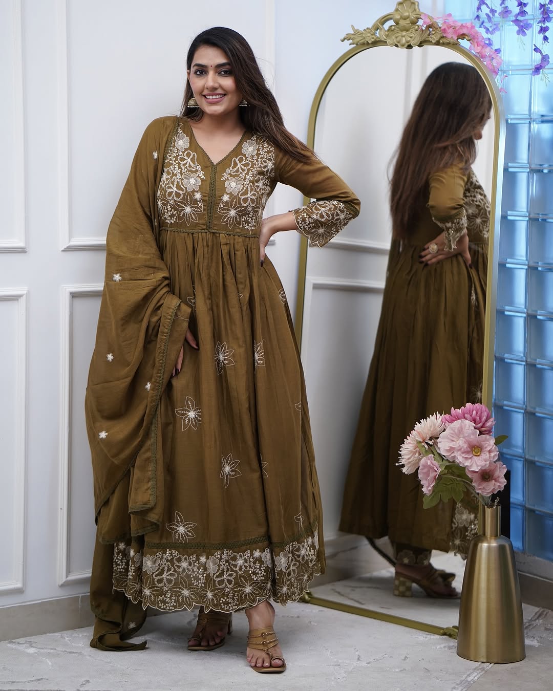 Confident pose of model displaying the full length of the TRENDBUY Sapna olive green embroidered gown and pant set.