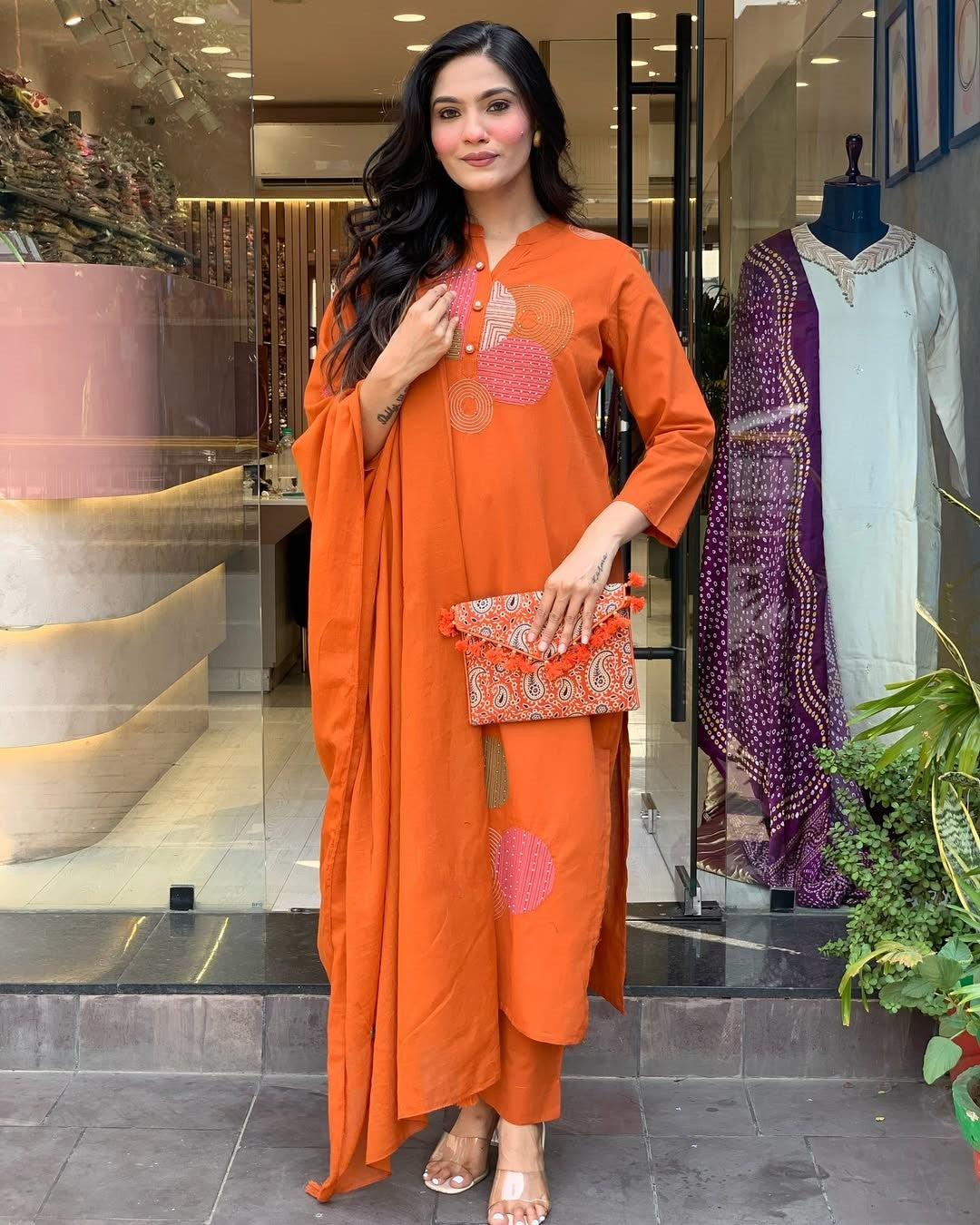 Front view of model in TRENDBUY ST-KASHMIRA bright orange kurti set, highlighting tassels