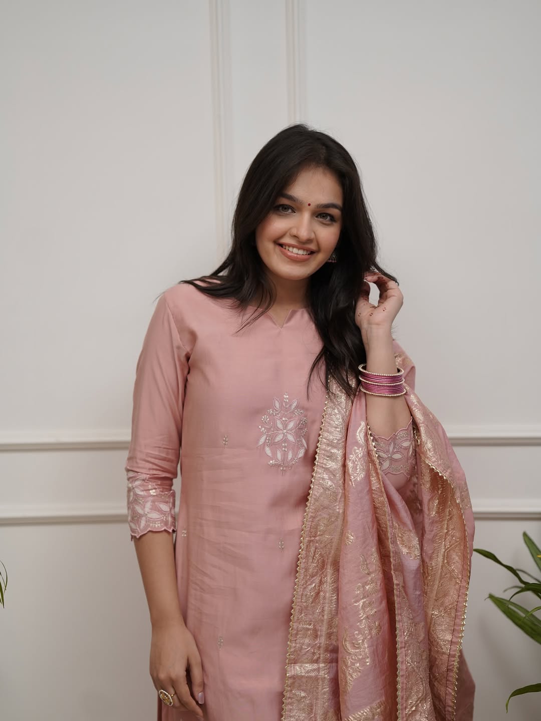 Model smiling broadly in TRENDBUY ST-SWATI peach kurti set, showcasing bangles and overall joyous expression, highlighting the vibrant appeal.