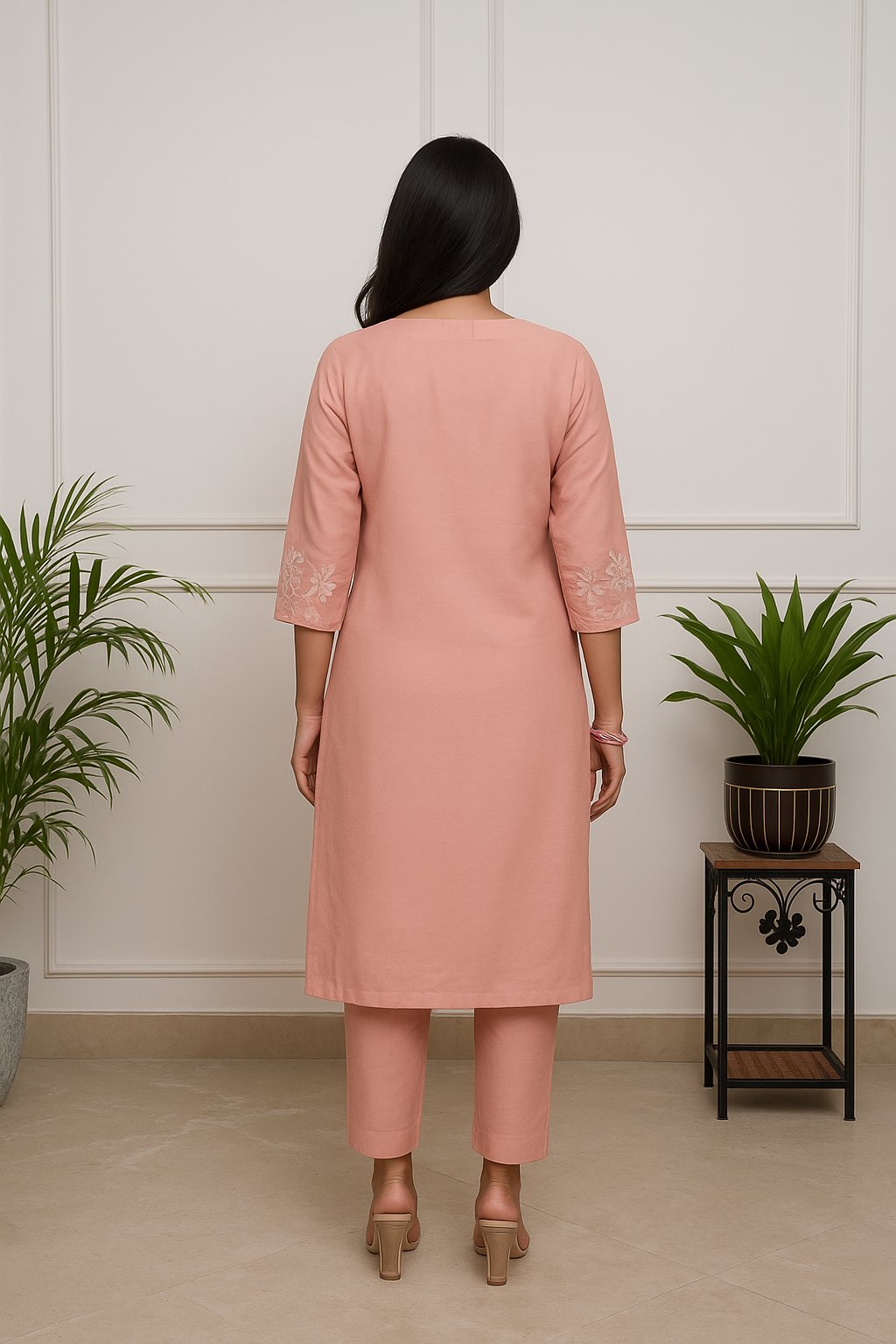Rear view of model wearing TRENDBUY ST-SWATI peach kurti set, displaying the full length of the kurti and pant, with minimal back detail.