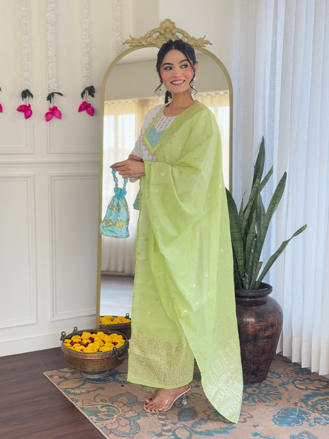 Woman smiling, showcasing the flow and elegance of the white Viscose Chanderi kurta and light green dupatta.