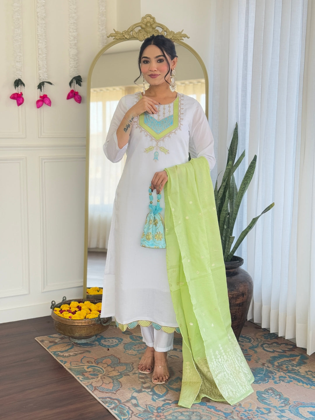 Full body shot of the model gracefully holding the lime green dupatta, featuring the complete ensemble.