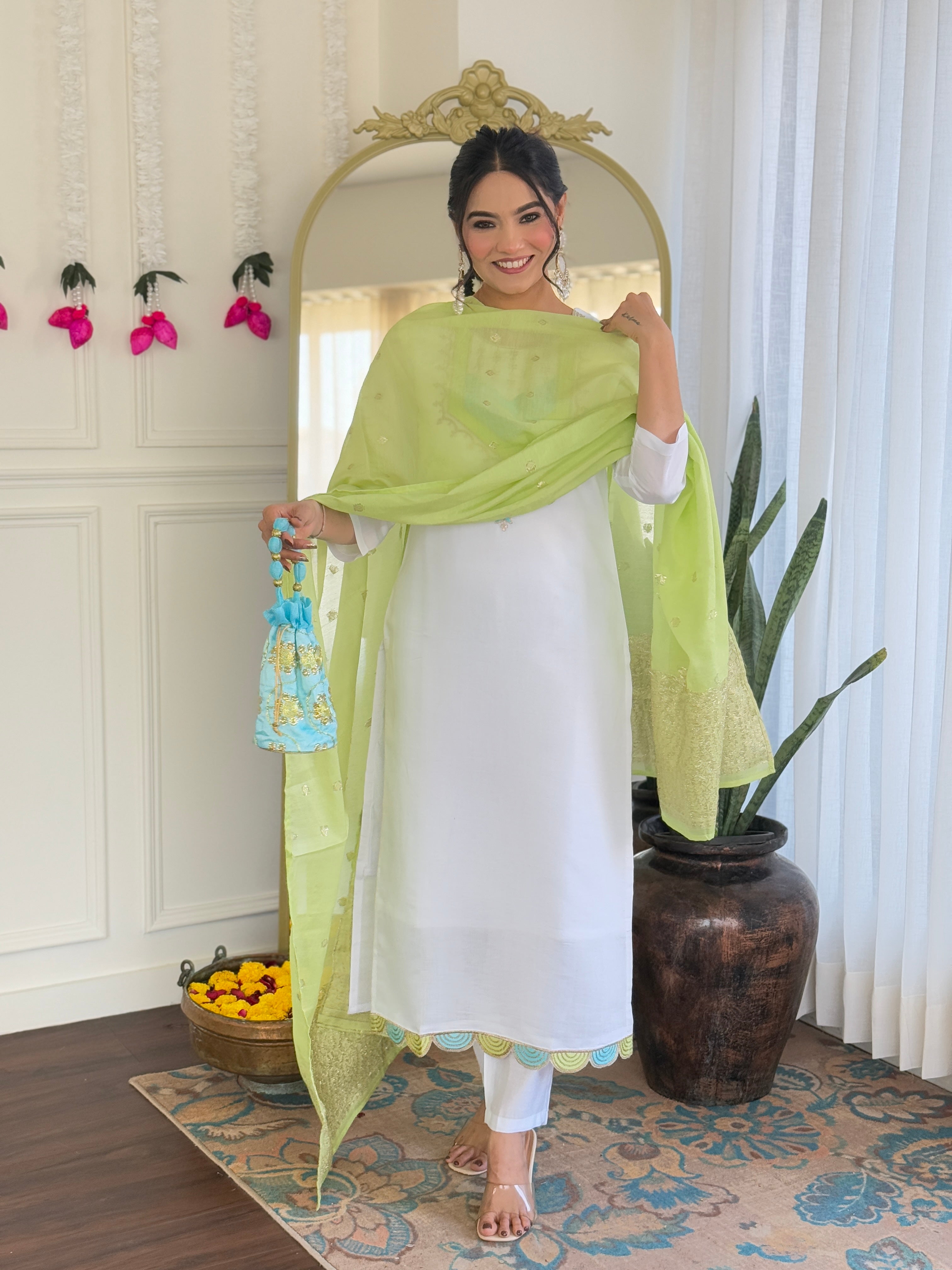 Smiling model adjusting the lime green embroidered dupatta, emphasizing its texture and drape.
