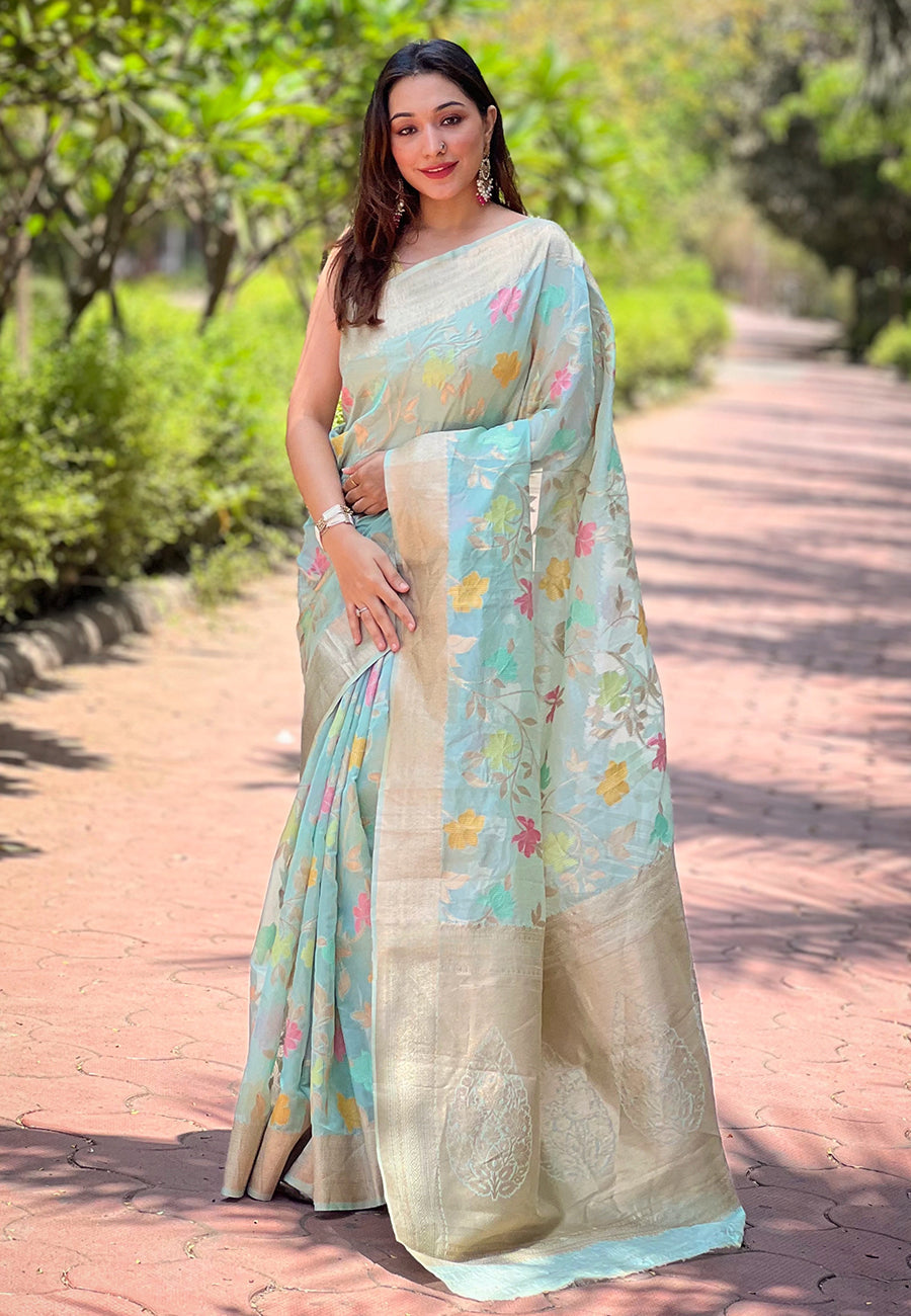 Skyblue organza saree with intricate floral zari weaving displayed elegantly.
