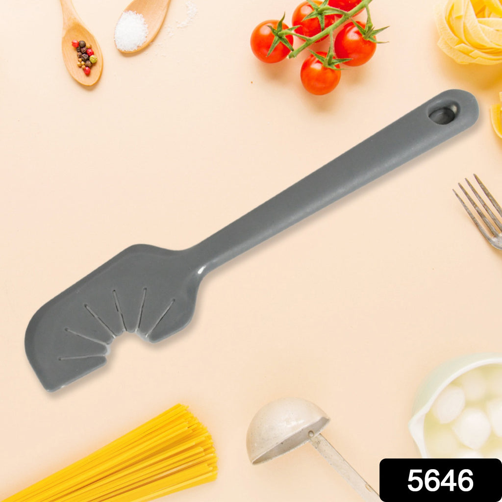 Silicon whisk scraper tool cleaning batter off a metal whisk