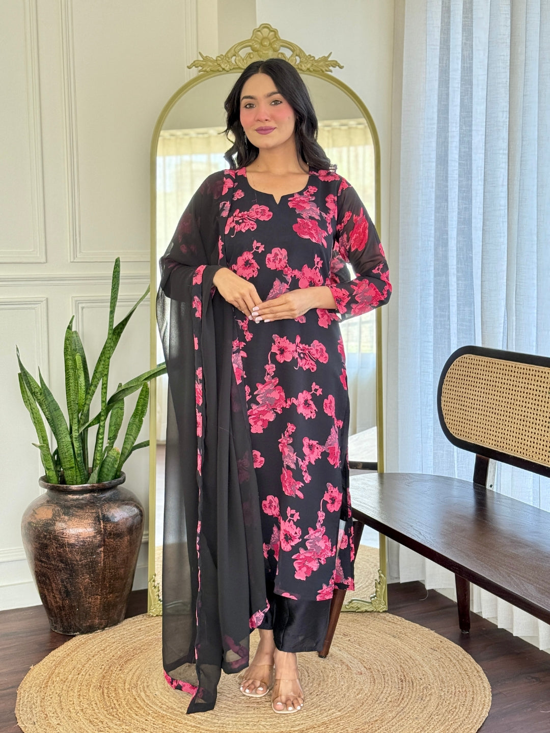 Model showcasing the full TRENDBUY black georgette floral kurti set with pink flowers, posing gracefully.