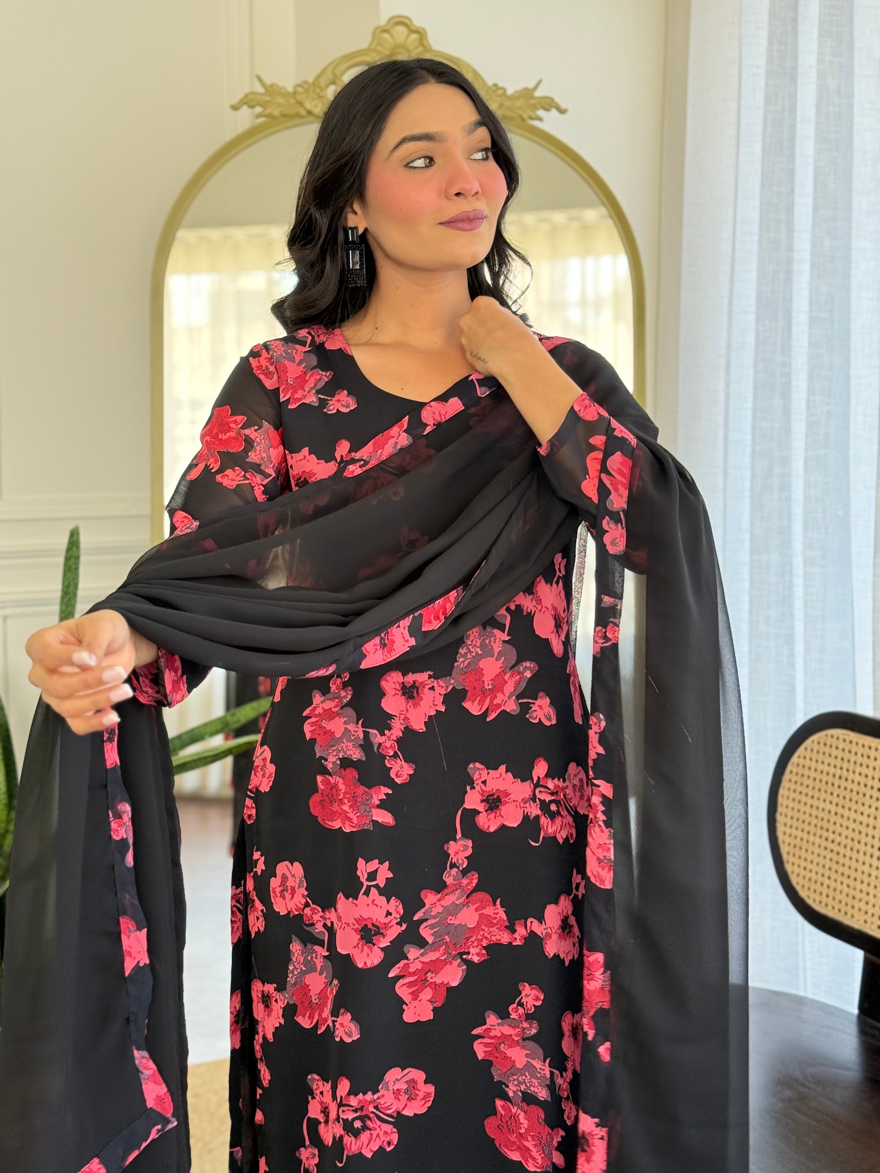 Close-up of the TRENDBUY floral printed georgette kurti and dupatta, showing the intricate pink floral design against the black fabric.
