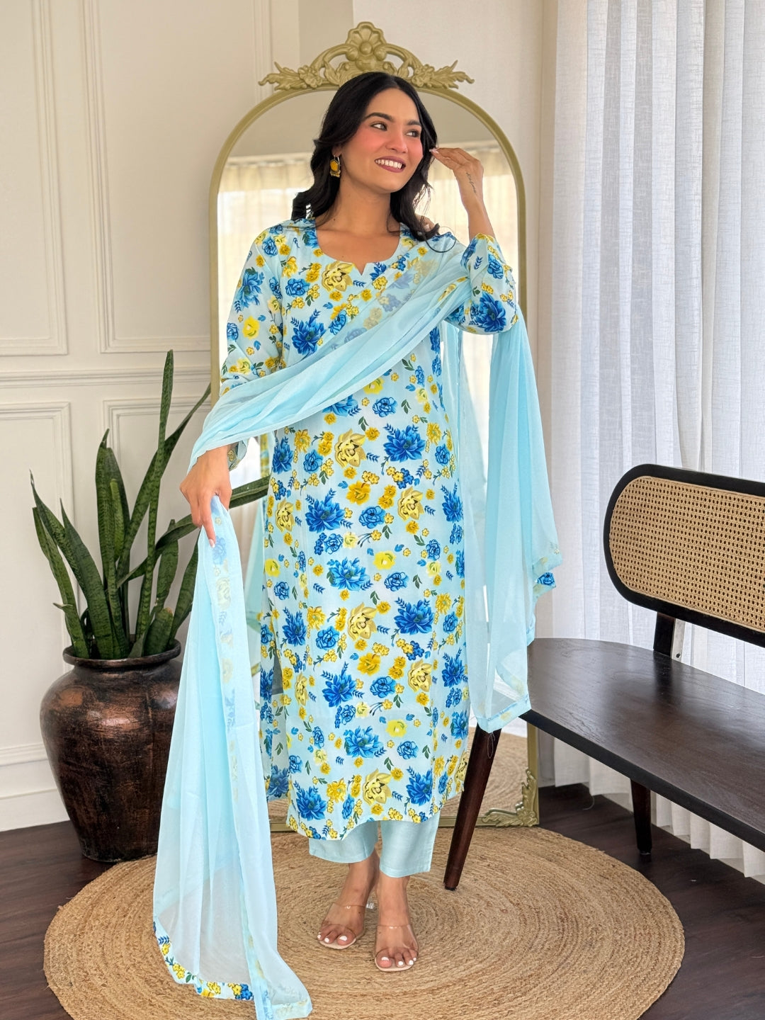 Model gracefully posing with the dupatta of the TRENDBUY blue and yellow floral kurta set.