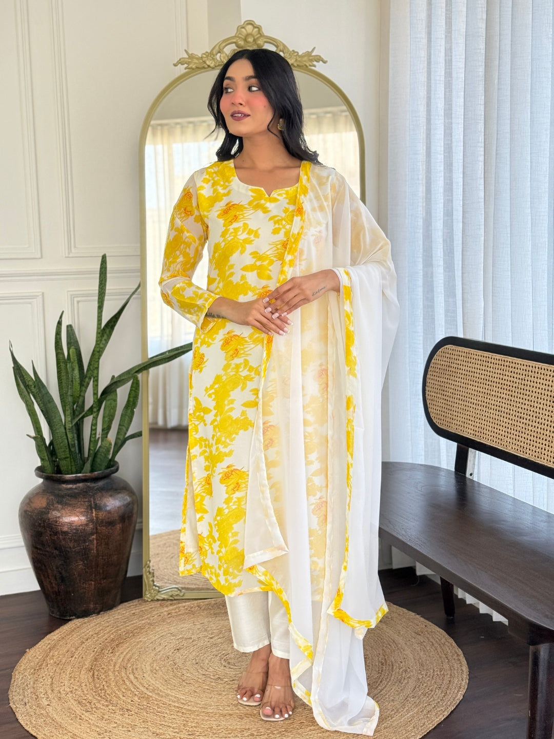Full shot of a woman wearing the TRENDBUY VI-204 yellow and white floral kurti set, highlighting its design and fit