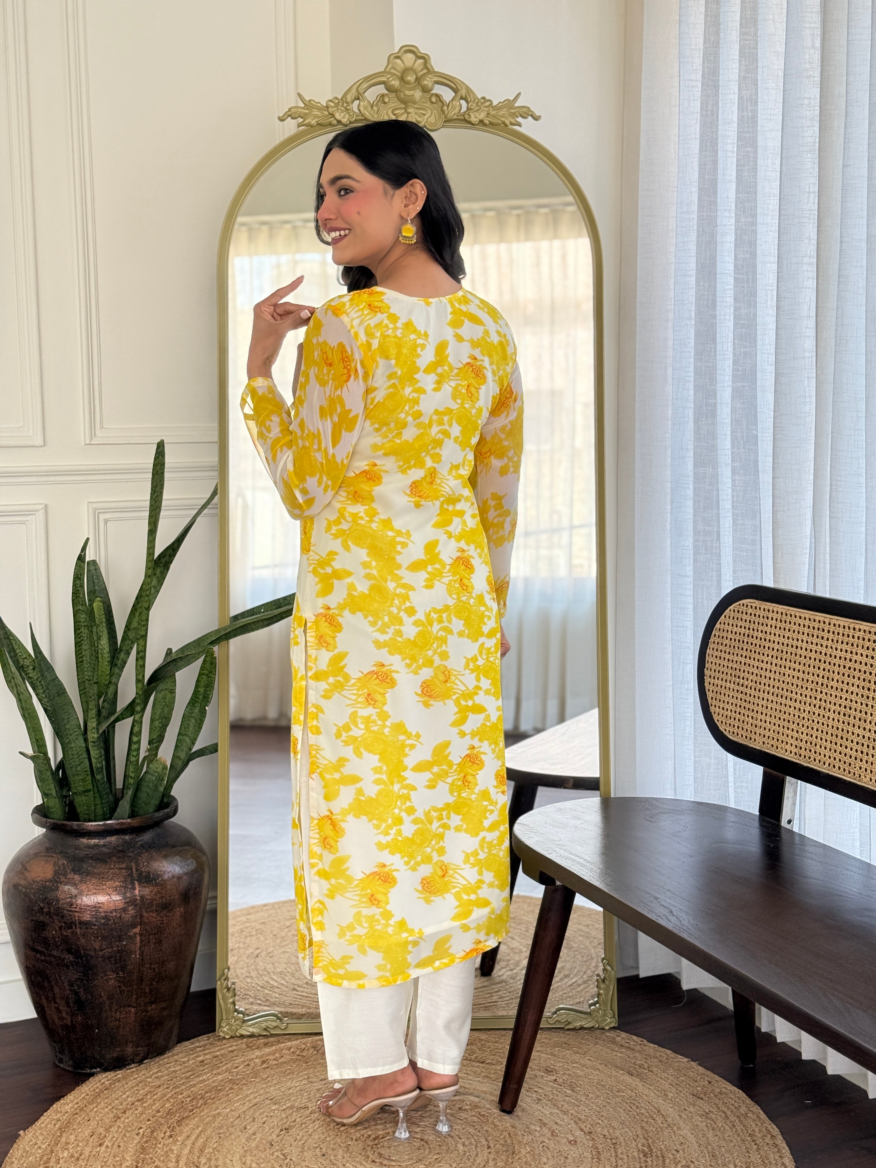 Back view of model in TRENDBUY yellow floral kurti set, showcasing the garment's flow and print from behind