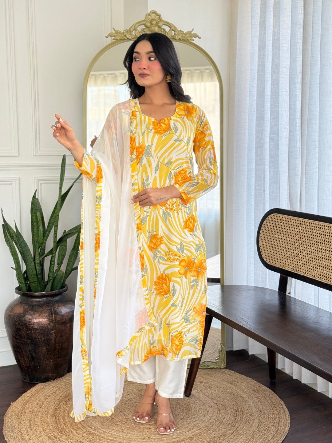 Model posing elegantly in printed georgette kurta set with white dupatta, showcasing the design.