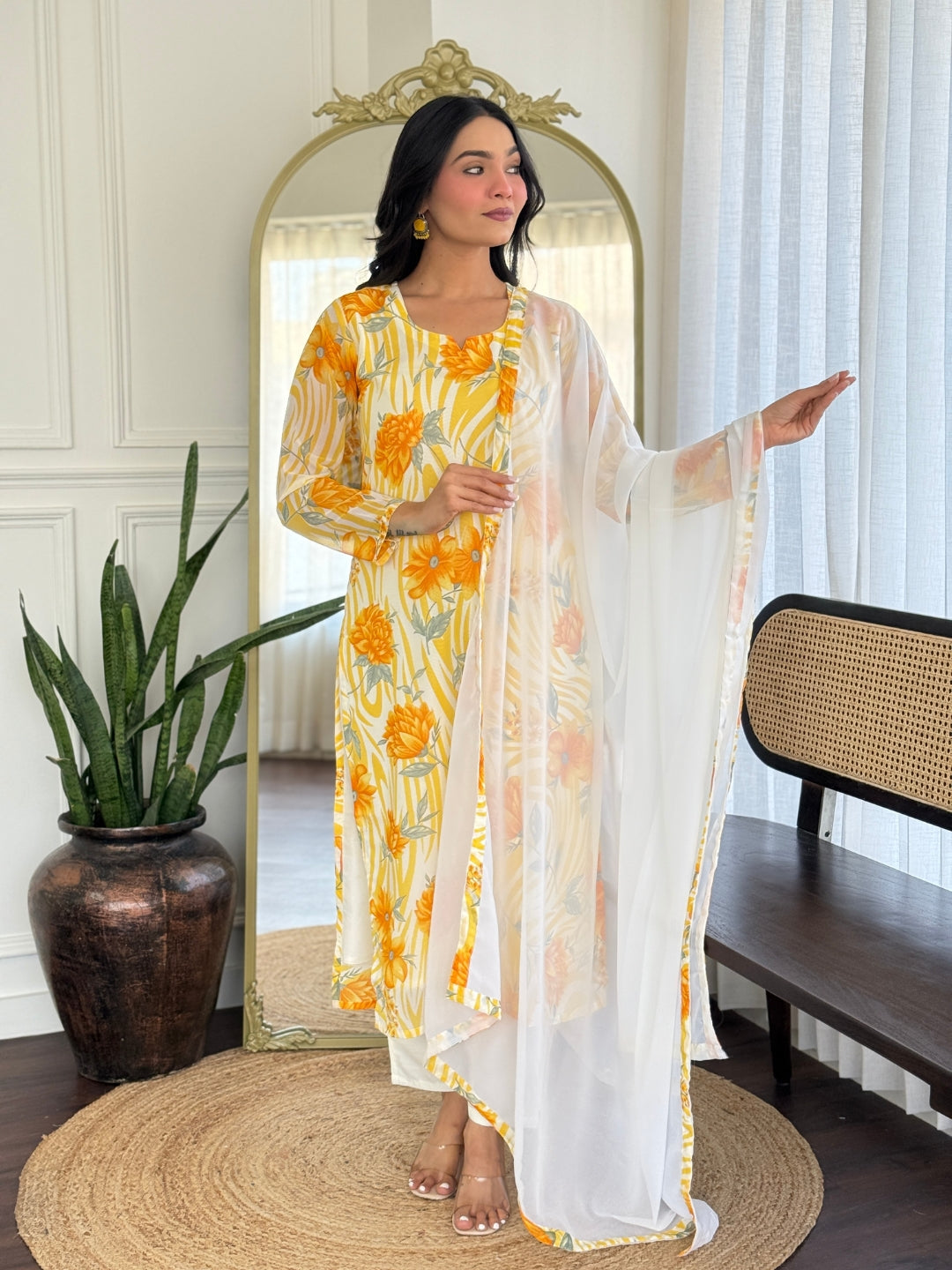 Side profile of model showcasing the flow and vibrant print of the georgette kurta and dupatta ensemble.