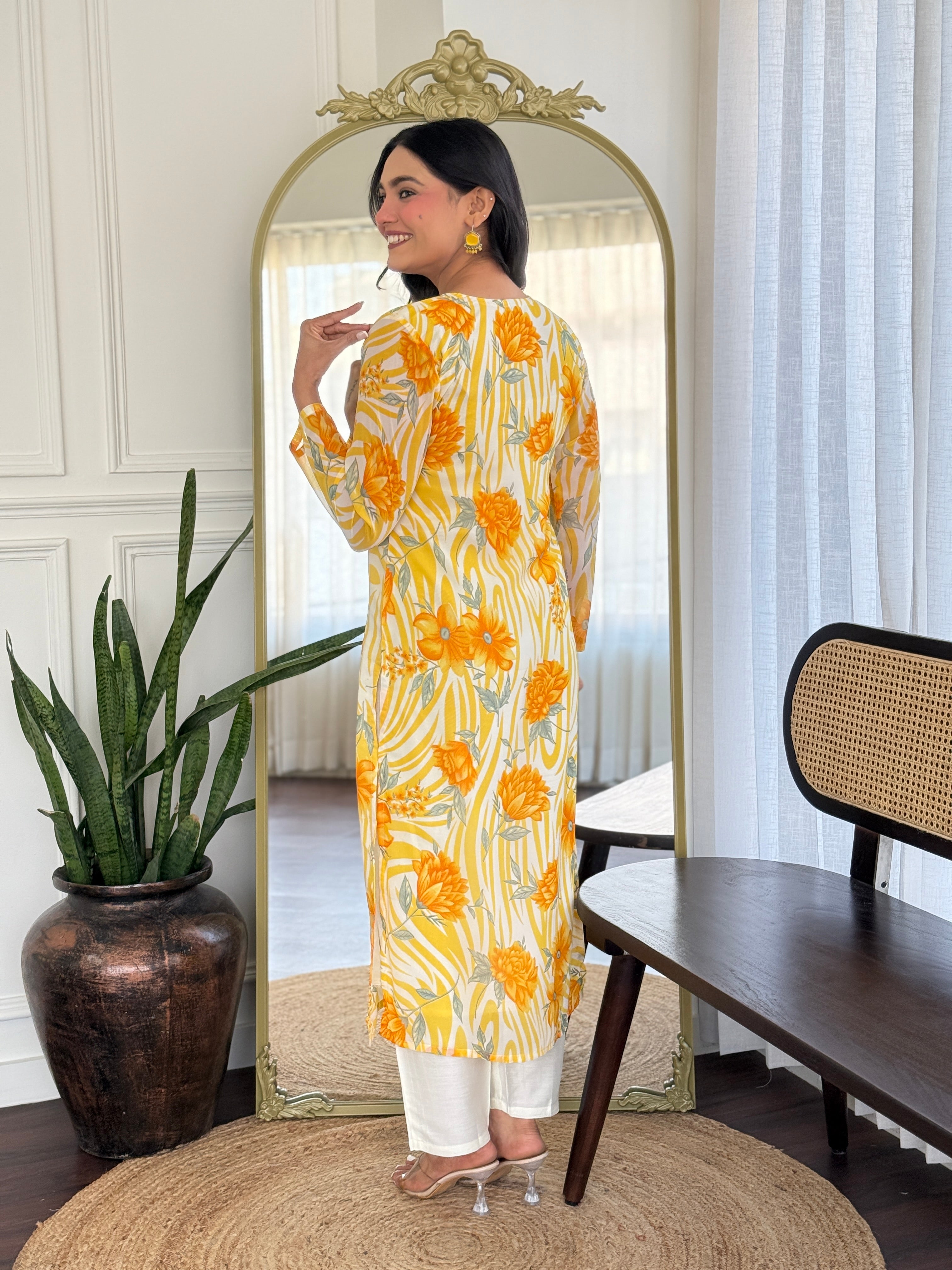Back view of the model highlighting the full yellow floral print of the kurta and comfortable chanderi silk pant.
