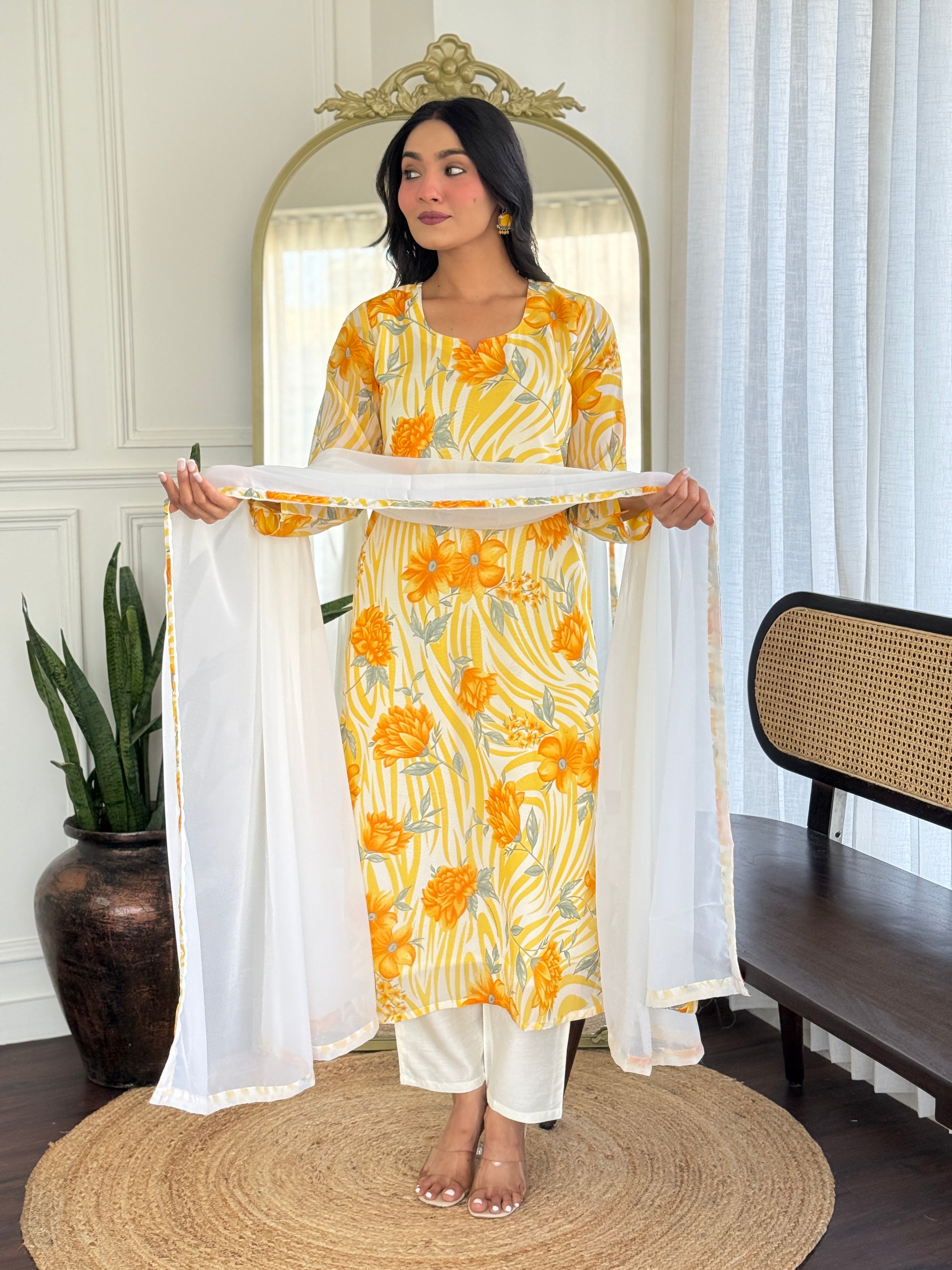 Model holding out the dupatta to emphasize its soft fabric, intricate border, and perfect match to the kurta.