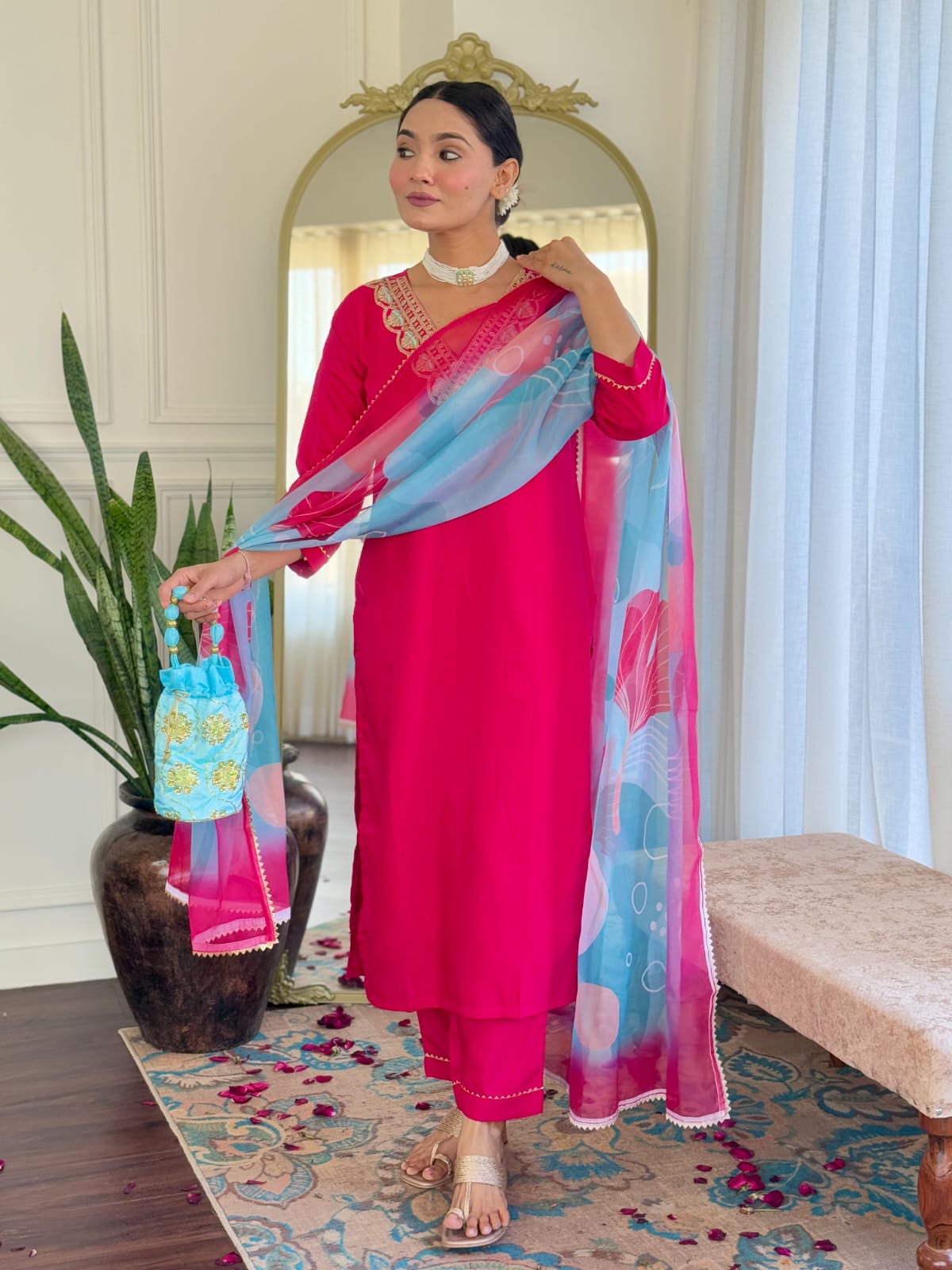 Model gracefully displaying the flowing Teby silk dupatta with pink and blue floral patterns, paired with a hot pink embroidered kurti set.