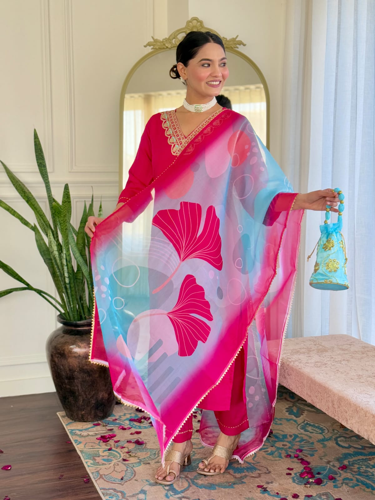 Smiling woman in a bright pink kurti set, highlighting the beautiful drape and vivid print of the Teby silk dupatta.