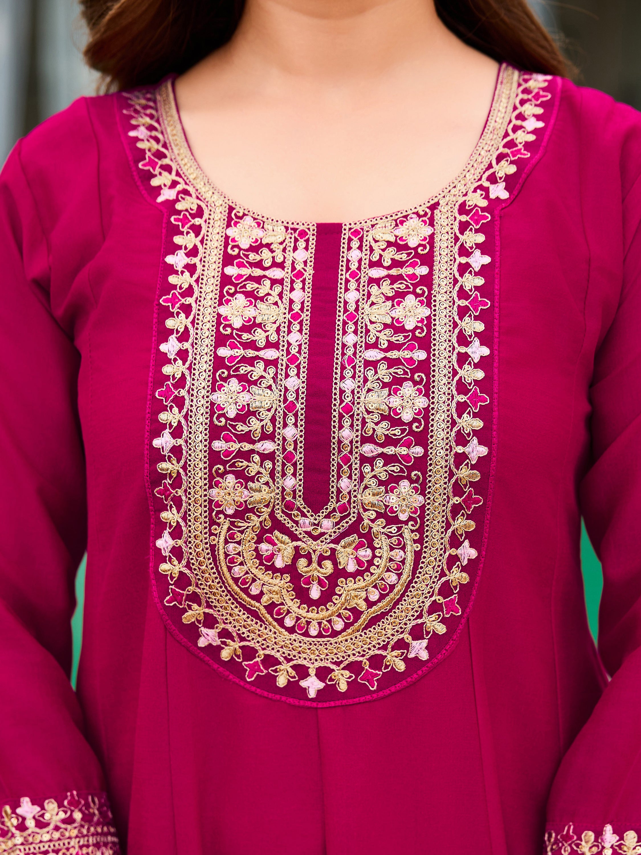 Intricate golden embroidery detail on the neck and hem of the TRENDBUY VI-SHAKTI Rani Pink Vichitra kurti.