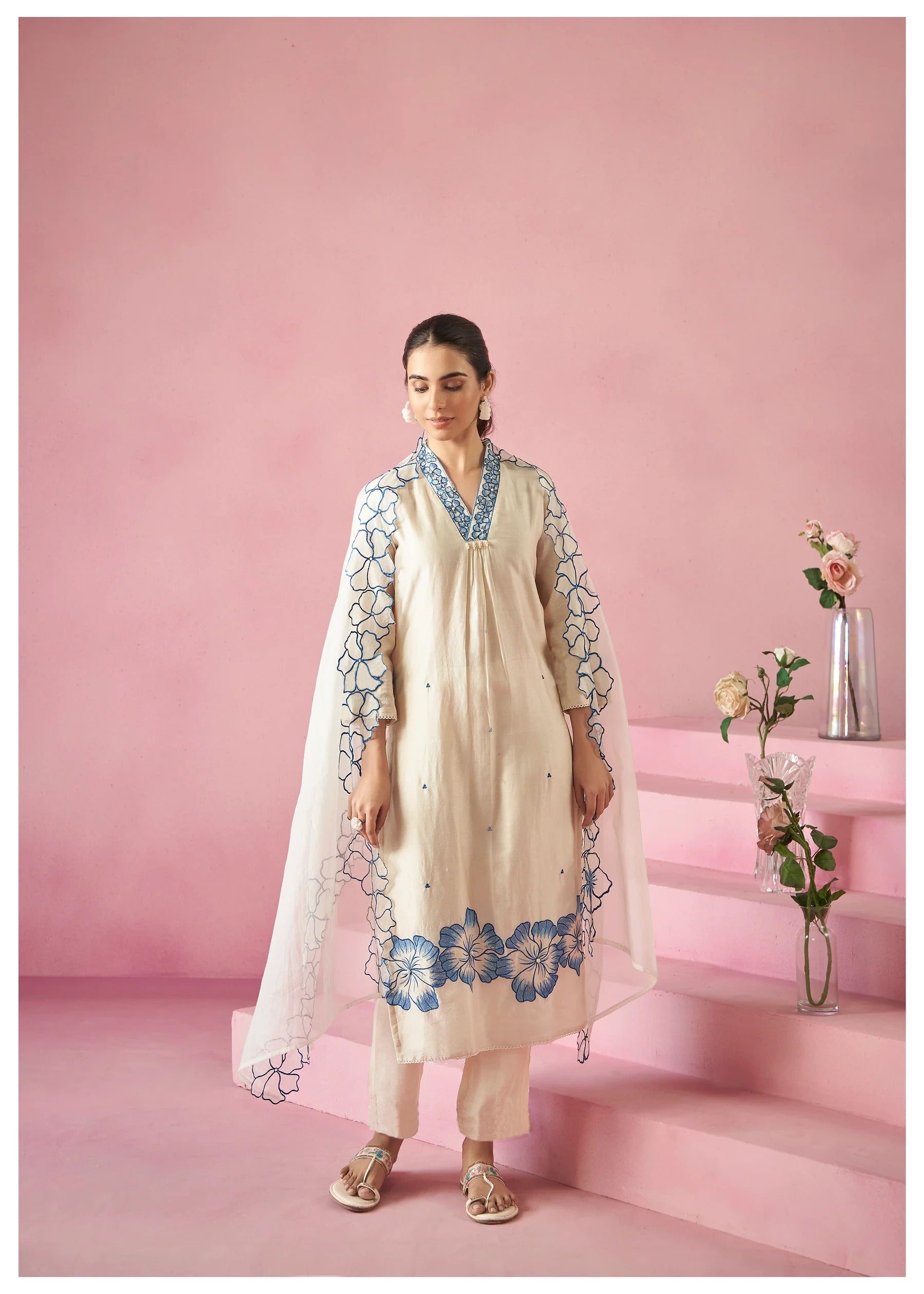 TRENDBUY model in white embroidered kurti set, with blue floral dupatta gracefully draped over shoulders, highlighting the intricate design.