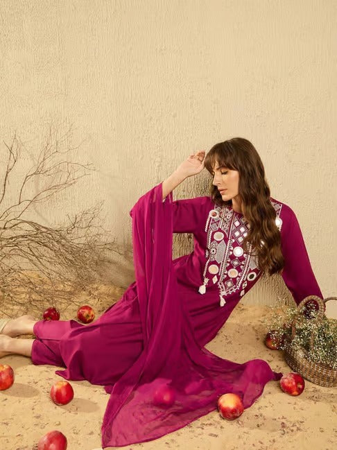 TRENDBUY model reclining gracefully, showcasing the pink embroidered Kurti Pant and Organza Dupatta ensemble