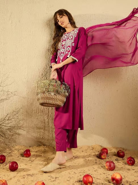 TRENDBUY model standing with a wicker basket, wearing the elegant pink embroidered Viscose Chanderi Kurti Pant and Organza Dupatta set
