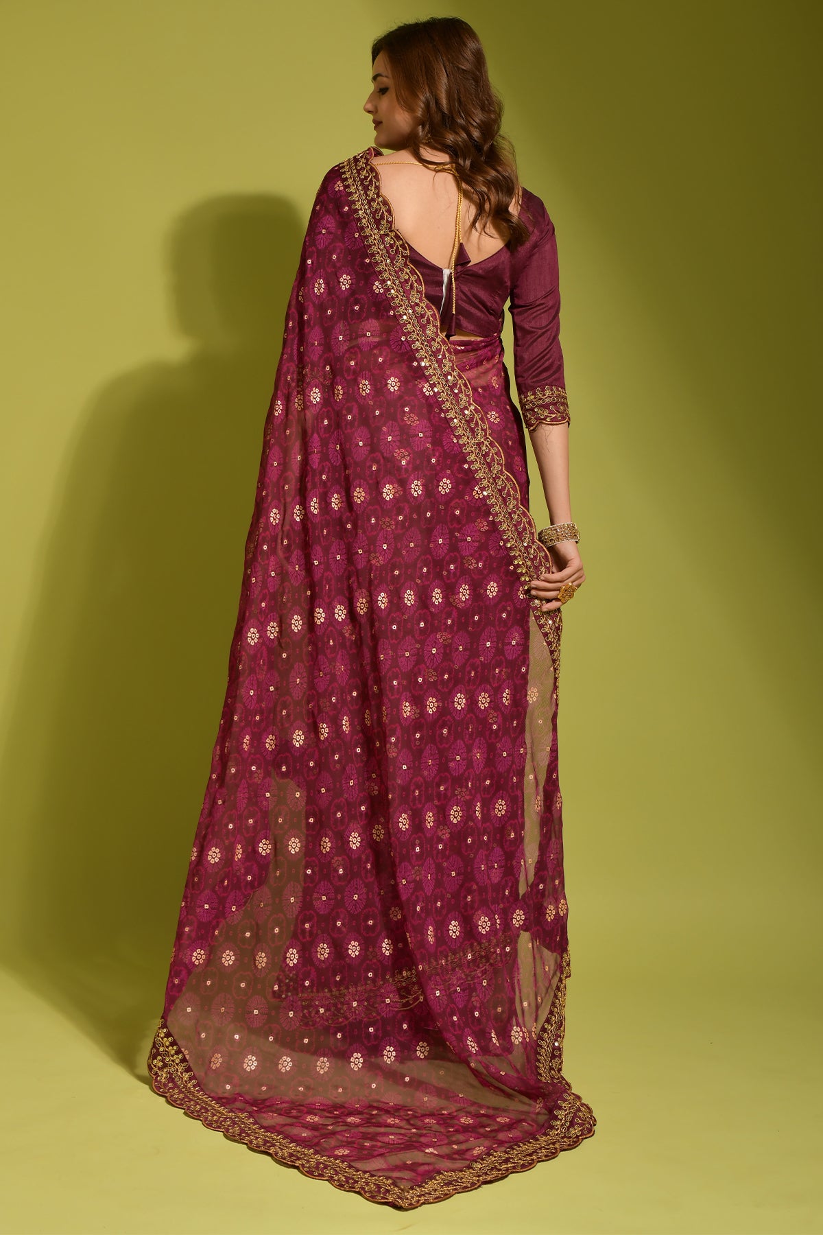 Exquisite wine georgette chiffon saree with flower print, foil & sequin work.