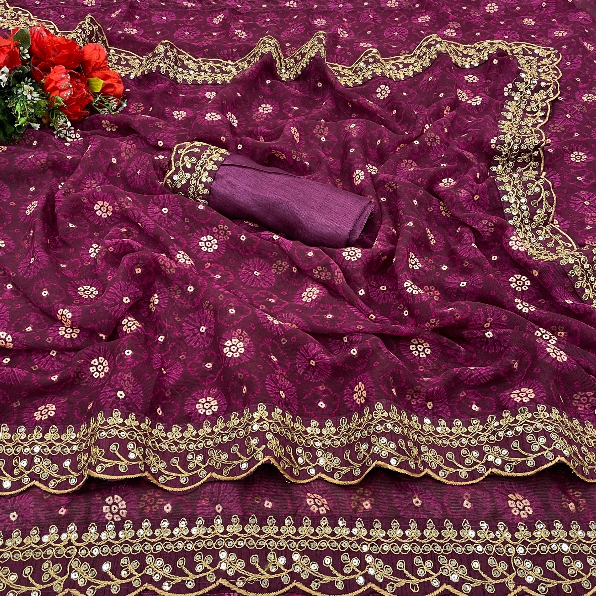 Close-up of wine georgette chiffon saree fabric featuring flower print, foil, and sequin work.