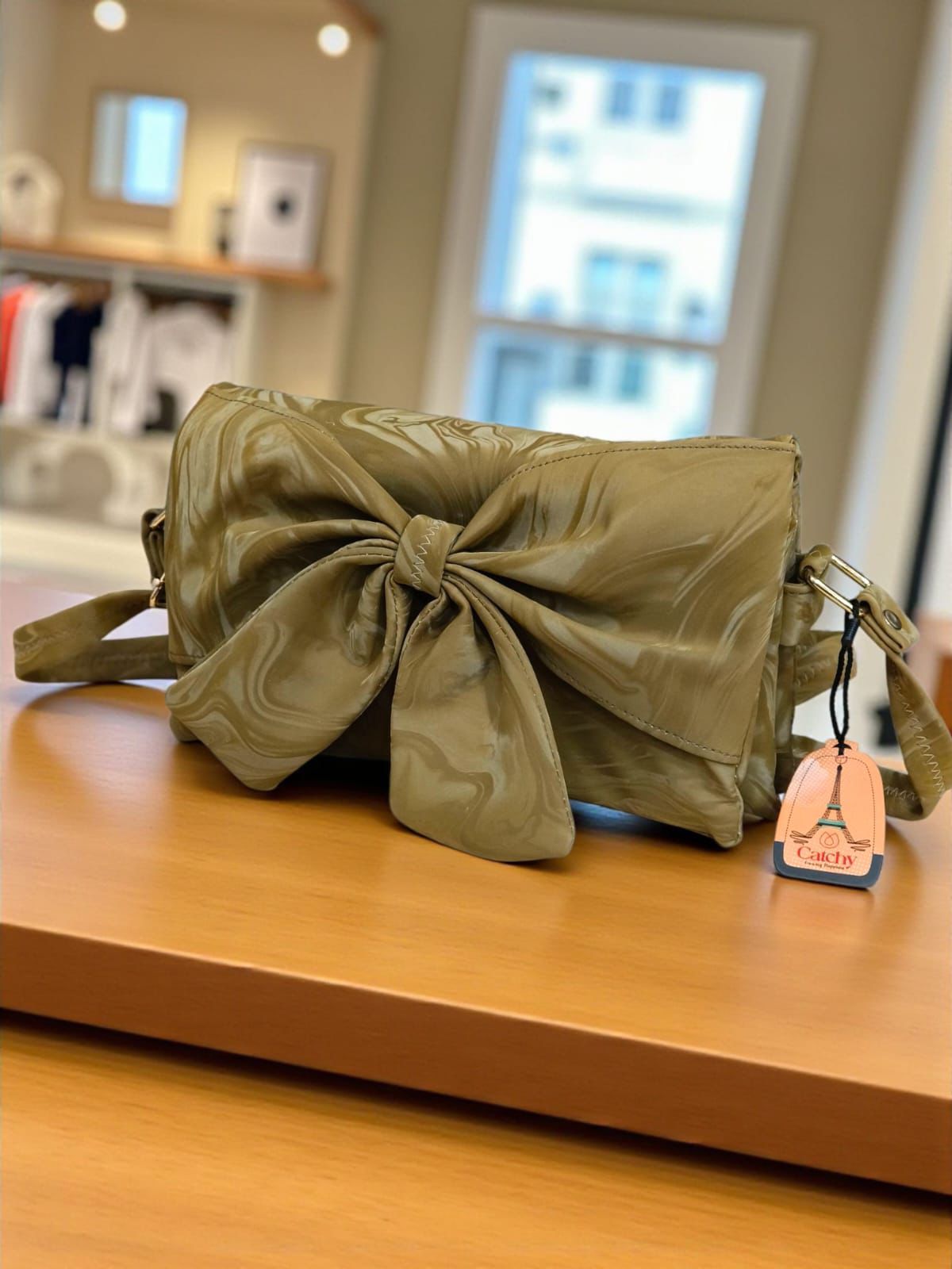 Green bag with a tag on a wooden surface