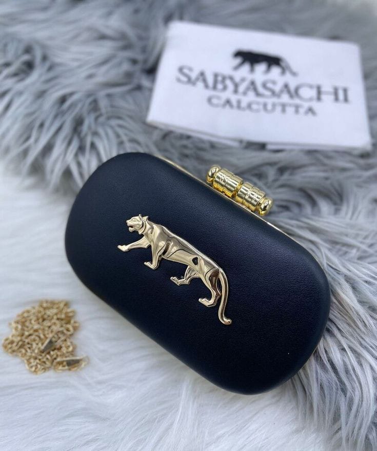The black Sabyasachi-inspired box clutch with a gold Royal Bengal Tiger motif