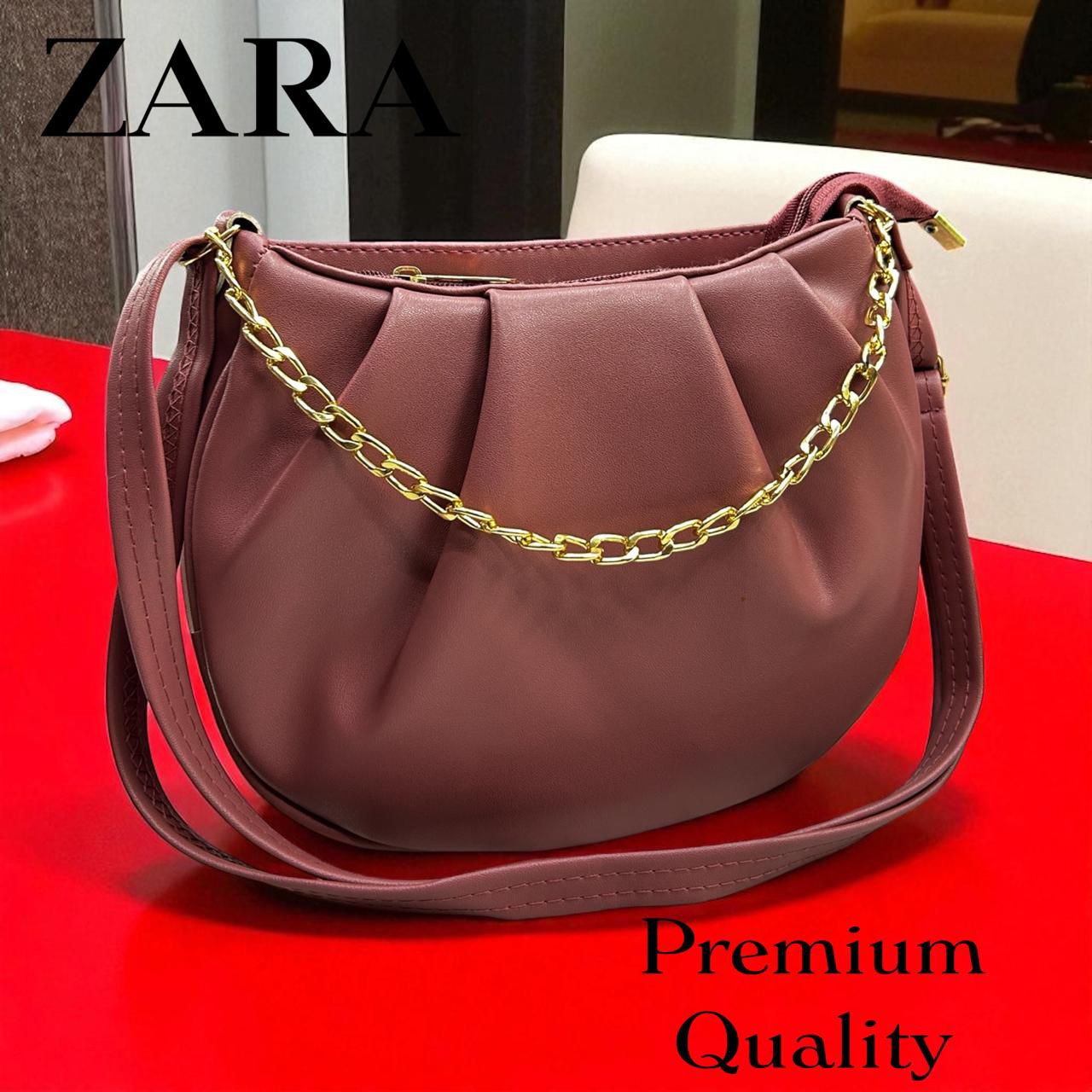 Zara handbag with gold chain on a red surface