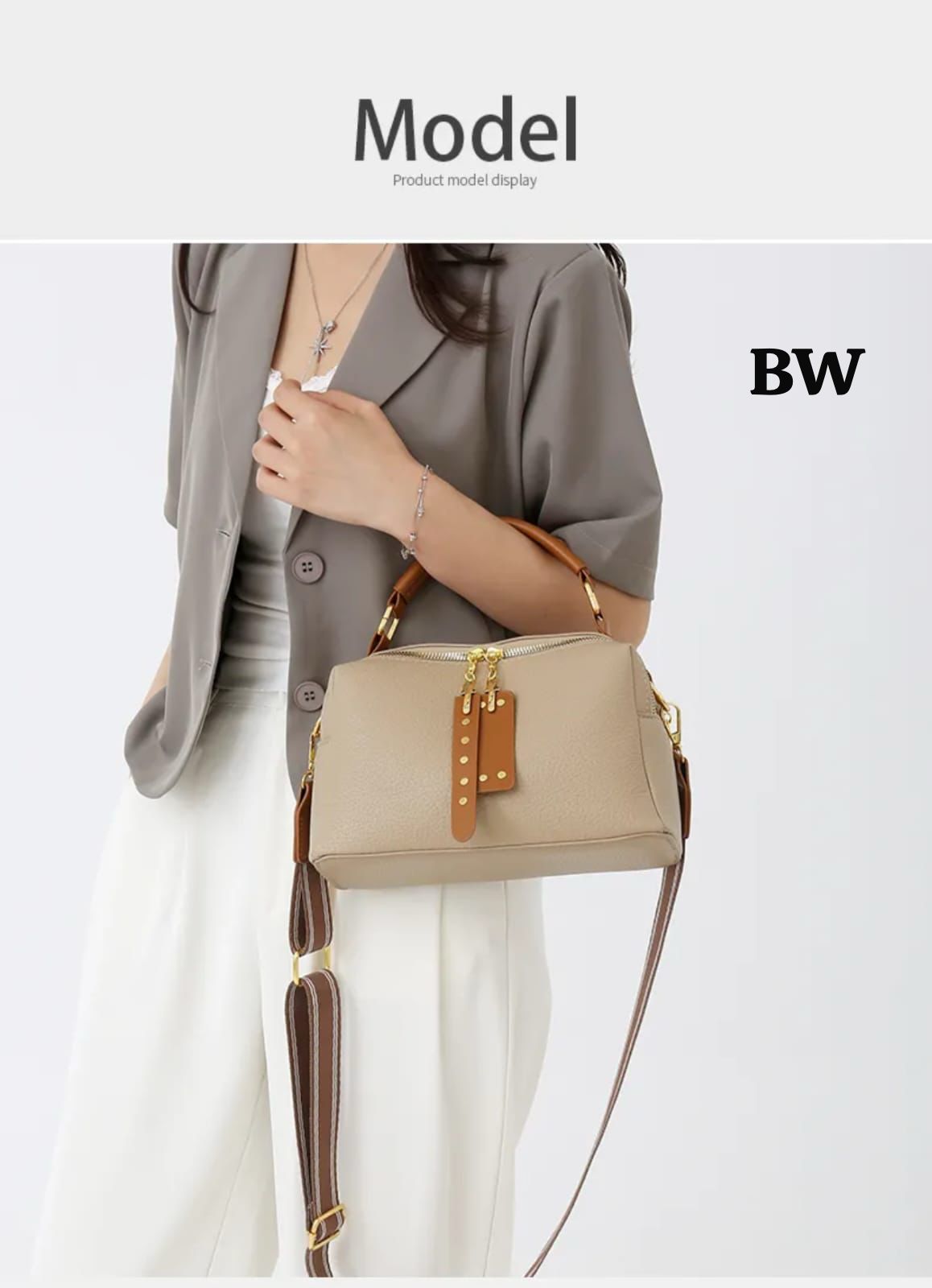 A woman wearing the black crossbody bag with the long striped strap