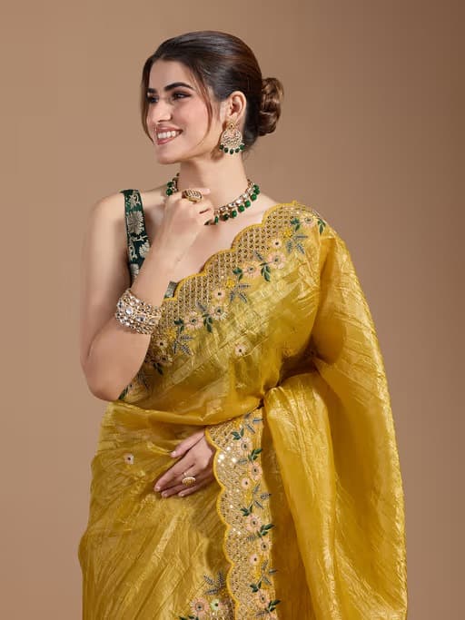 Elegant yellow wedding gold crush saree with luxurious fabric and traditional accents.