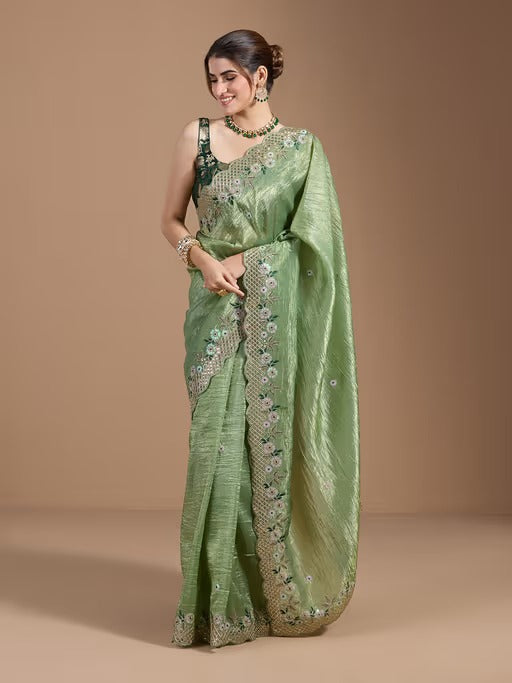 Close-up of intricate gold coding embroidery and delicate cut border work on the pallu