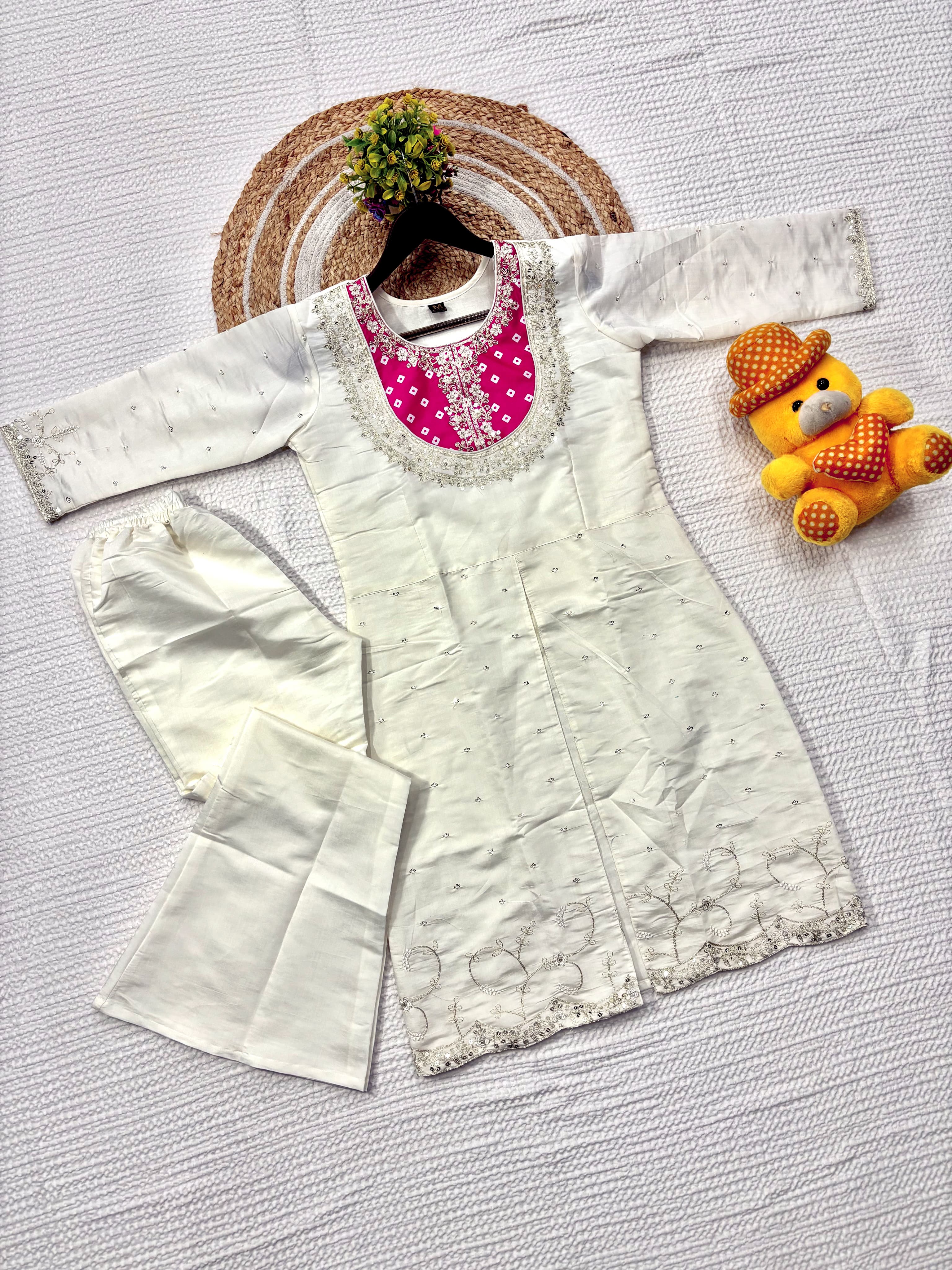 Flat lay of TRENDBUY K501 Roman Silk Palazzo Kurta Set in cream with hot pink embroidered yoke and matching palazzo pants.