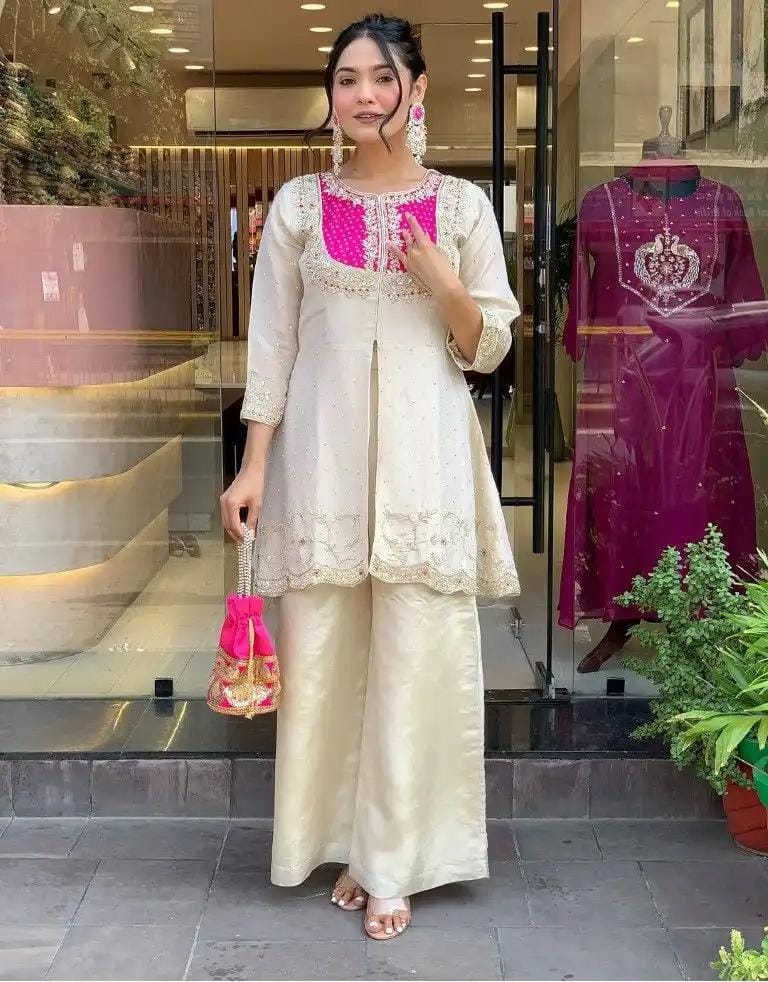 Model displaying the TRENDBUY K501 Roman Silk Palazzo Kurta Set with hot pink embroidered yoke, holding a potli bag.