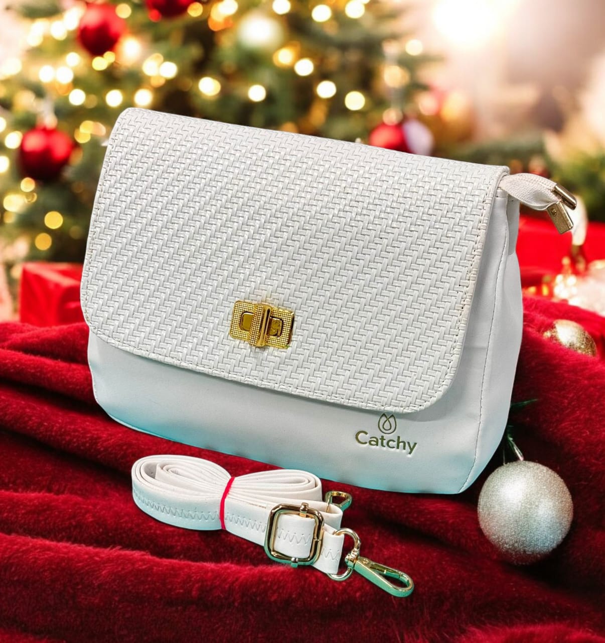 TRENDBUY Catchy White Faux Leather Crossbody Sling Bag featuring a braided texture flap and gold hardware, displayed on a red and white festive setting.