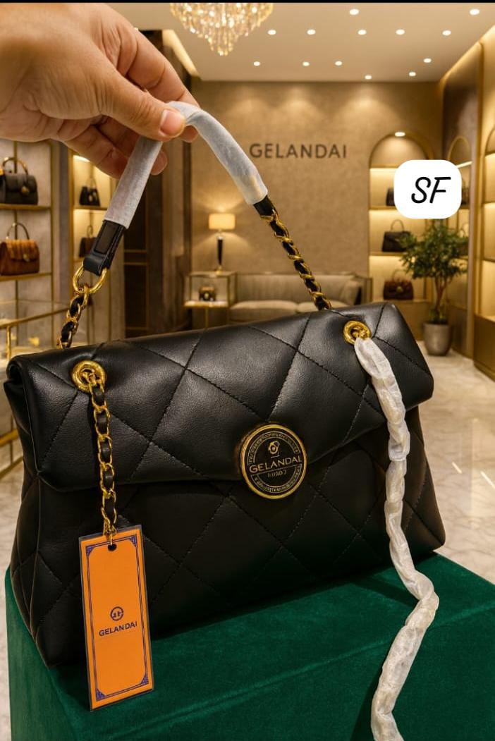 Close-up of the TRENDBUY Imported Quilted Sling Bag, highlighting its gold GELANDAI logo and chain strap with protective wrapping.