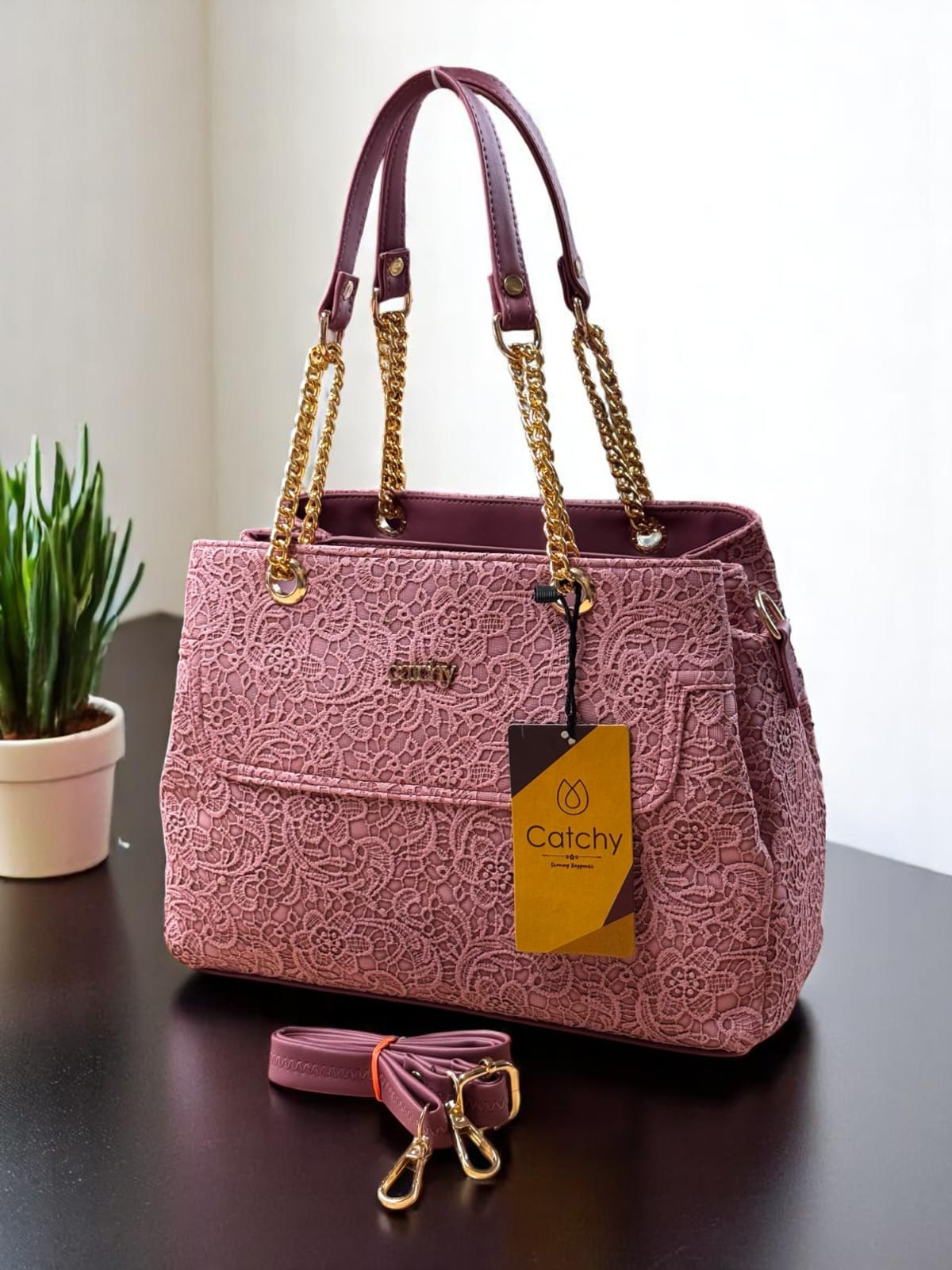 TRENDBUY Dusty Pink lace pattern handbag, a charming accessory with a luxurious finish and practical design.