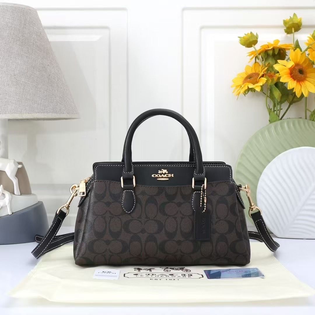 TRENDBUY Coach Darcie Handbag featuring dark brown signature monogram canvas with black leather trim, top handles, and a detachable strap, elegantly displayed.