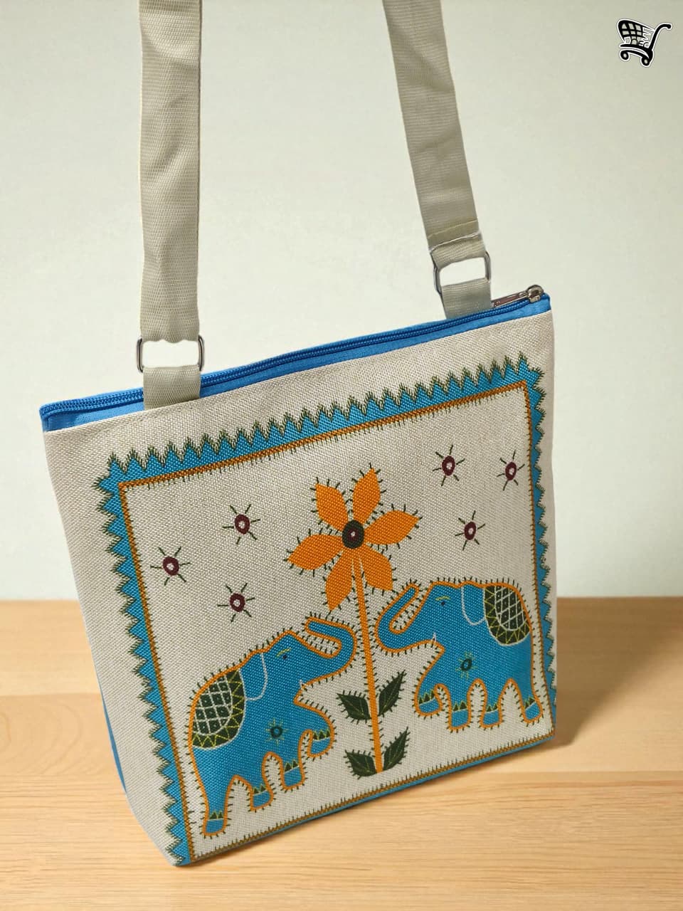 TRENDBUY blue elephant print jute shoulder bag, featuring the elephant and flower design, hanging against a plain wall.