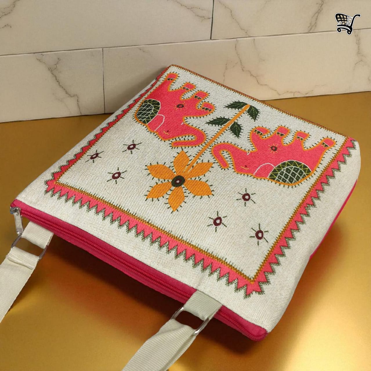 Overhead view of TRENDBUY pink elephant print jute sling bag on a luxurious gold-toned surface.