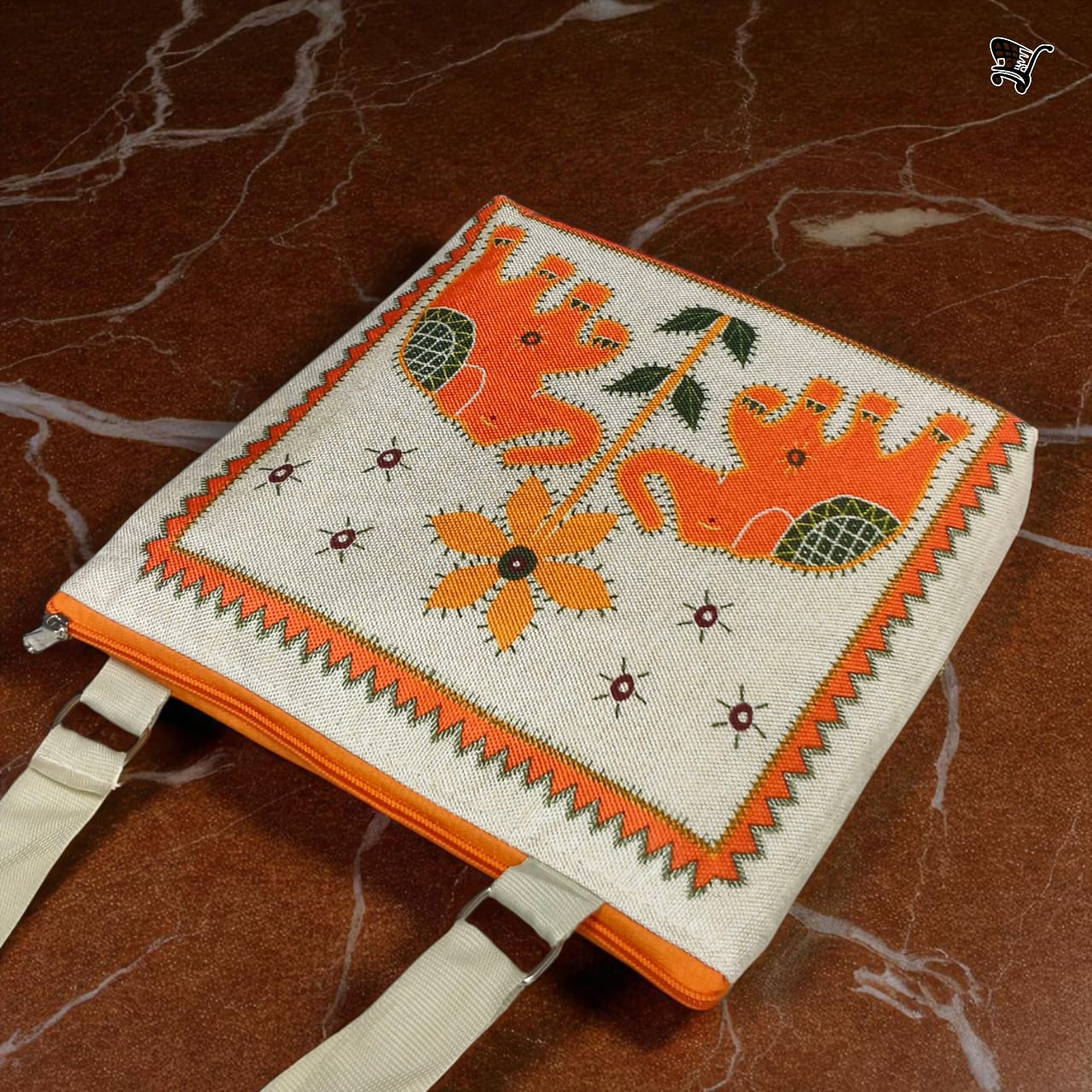 Top view of TRENDBUY orange elephant print jute sling bag, showing its two zippered compartments on a marble surface.