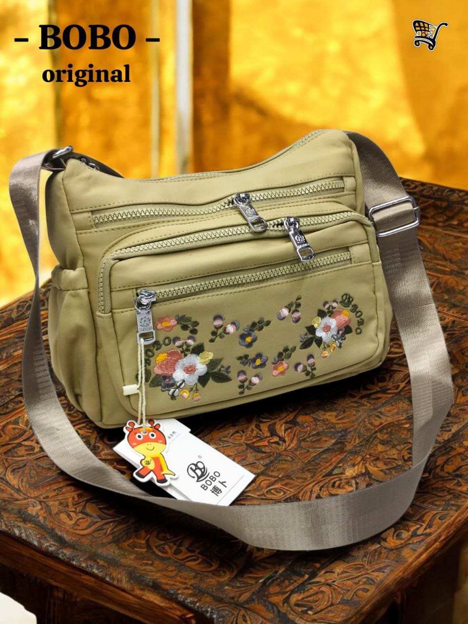TRENDBUY BOBO Original beige floral crossbody bag displayed on an intricate wooden table