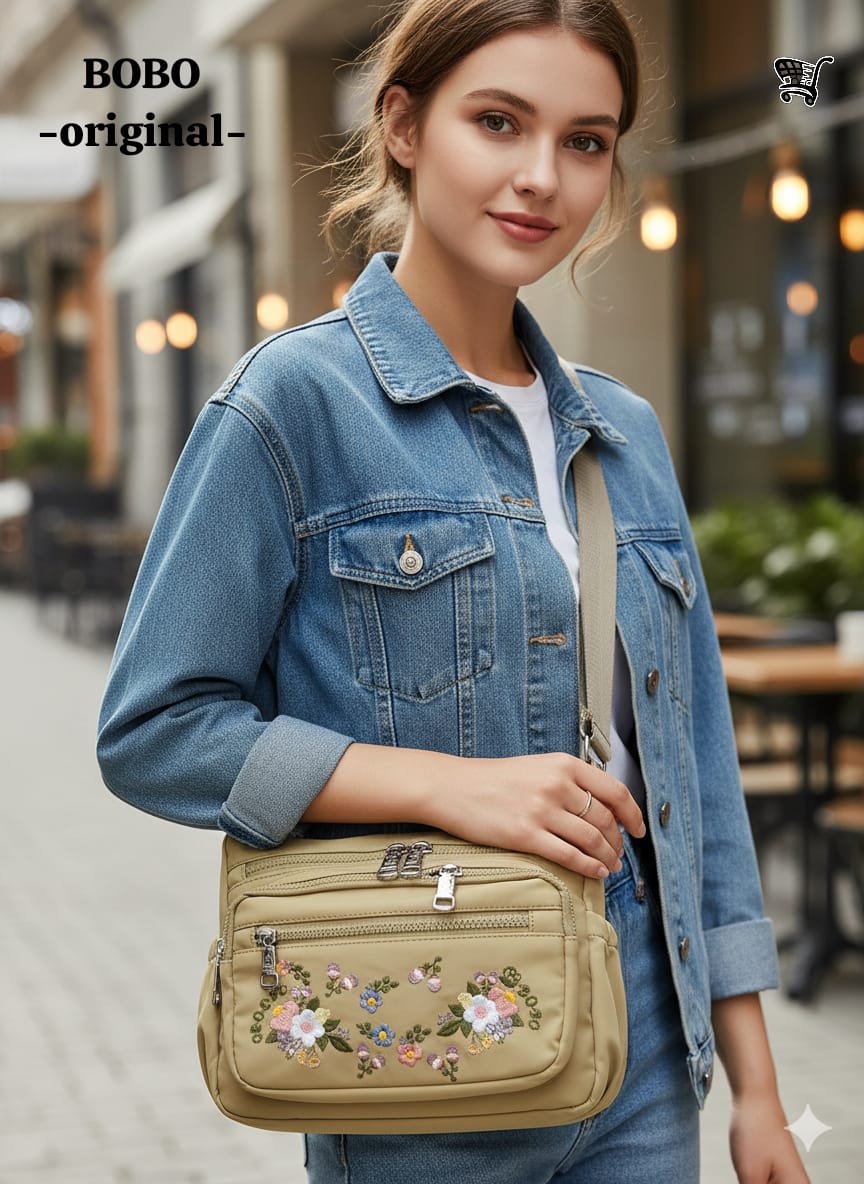 Stylish woman in a denim jacket carrying TRENDBUY BOBO Original beige floral crossbody bag on a bustling city street