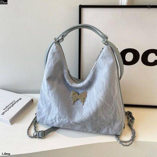 Modern light grey 2-in-1 handbag and backpack with chain details and a stylish butterfly embellishment.