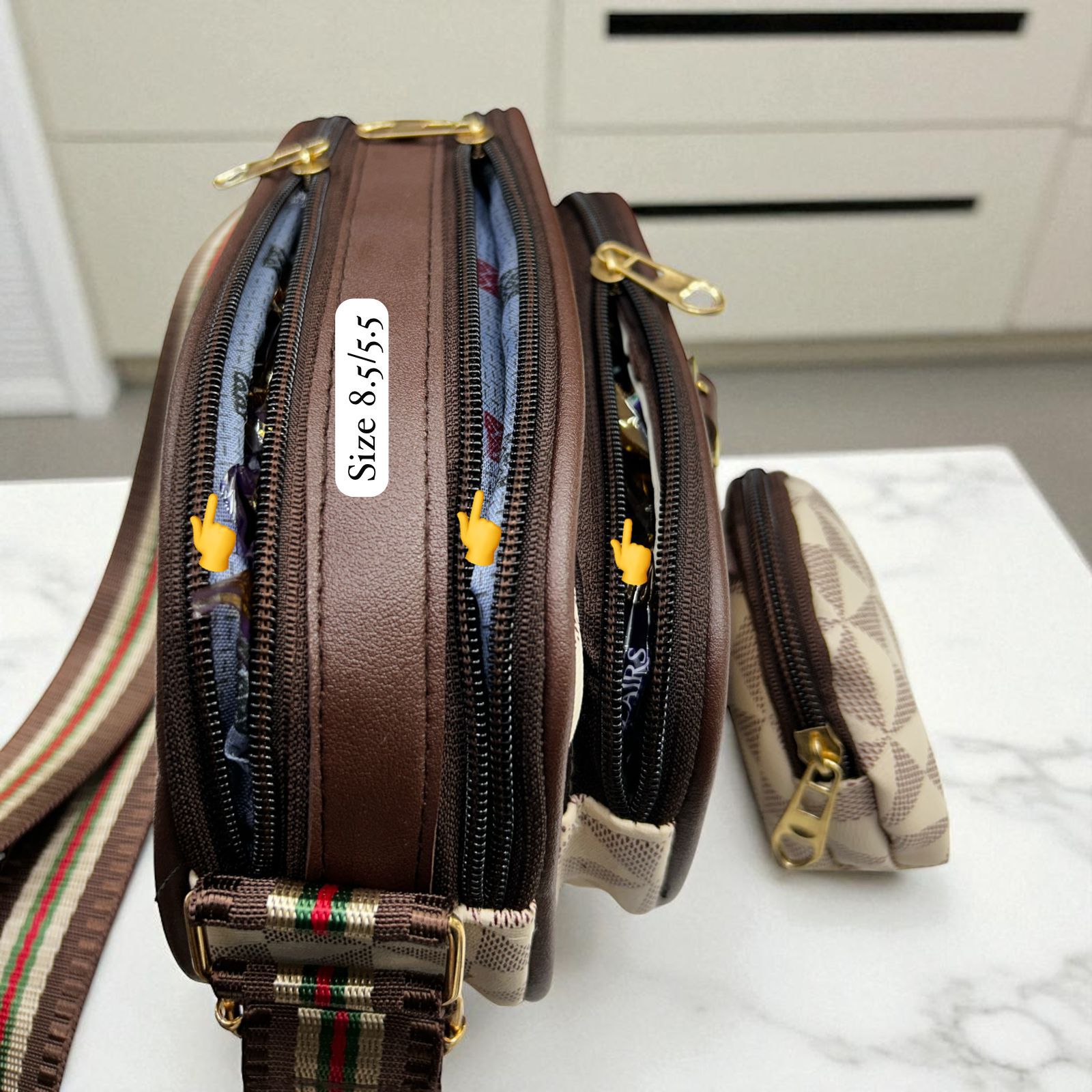 Close-up side view of Louis Vuitton style sling bag showing three main zippered compartments, internal lining, coin pouch, and size label (8.5/5.5).