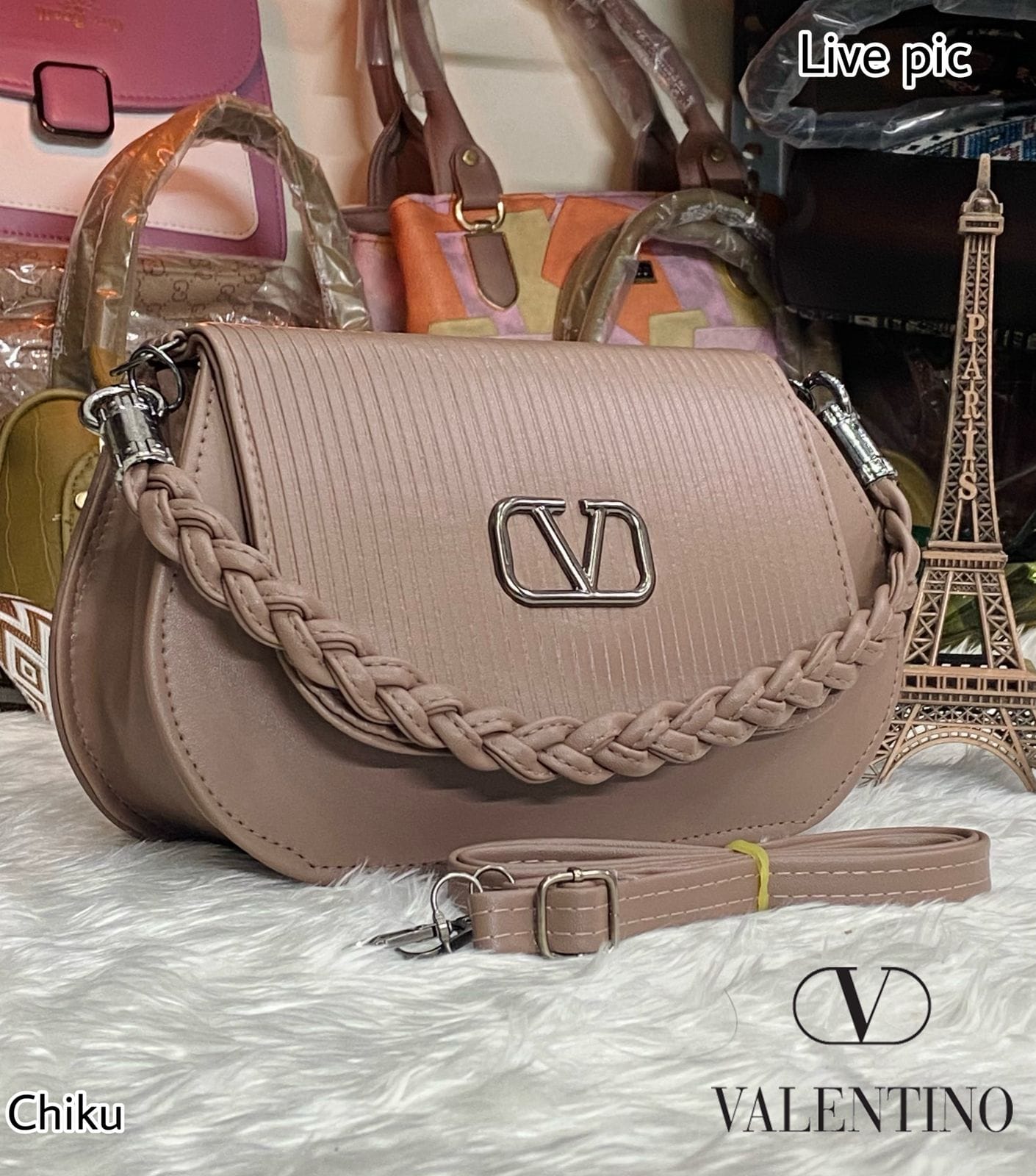 TRENDBUY Chiku Valentino-inspired crossbody bag with braided handle, front view on white fur.