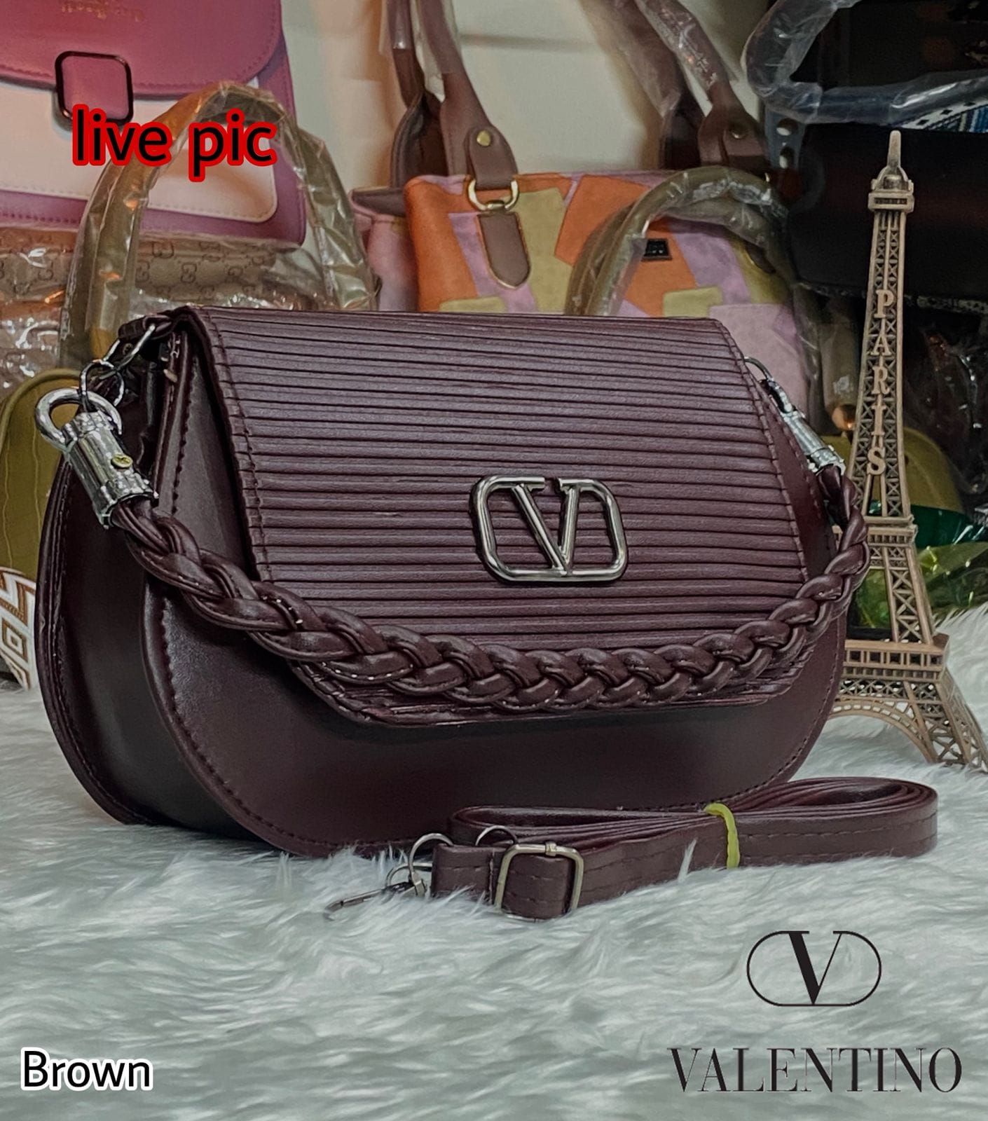 TRENDBUY Dark Brown fashion handbag with long adjustable strap on white faux fur background.