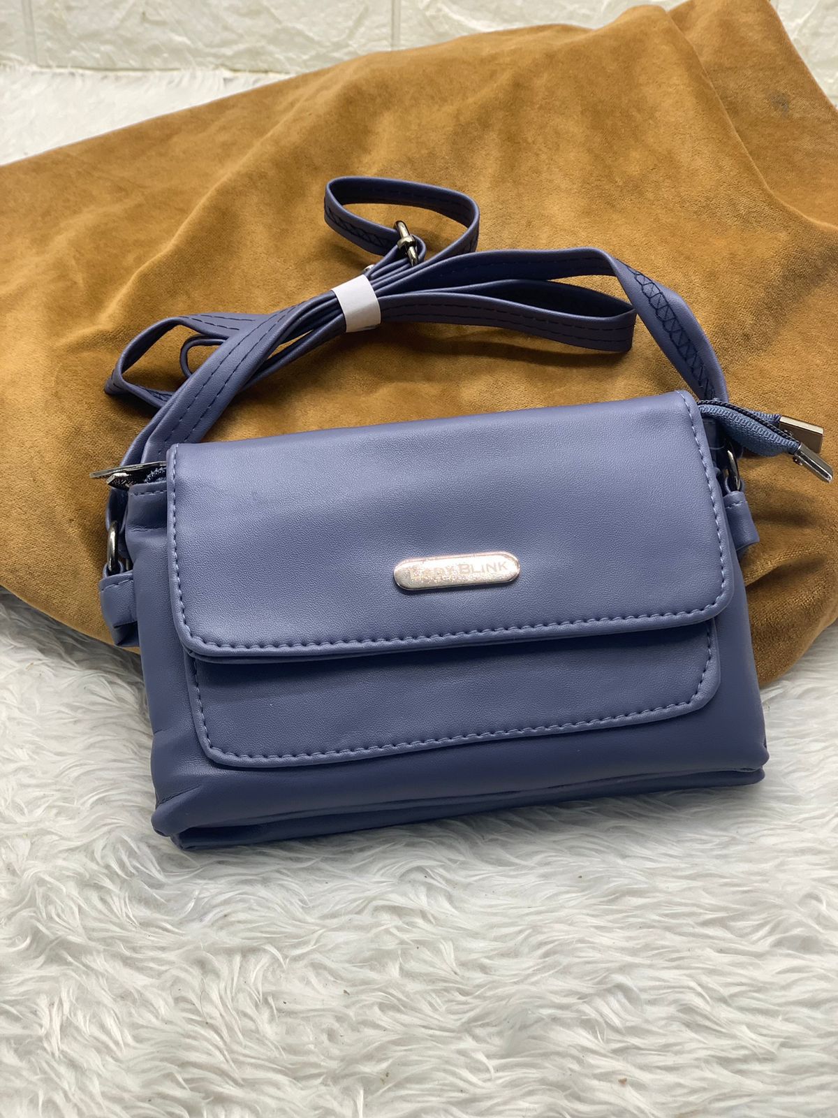 TRENDBUY periwinkle blue PU leather sling bag, with multiple compartments visible.