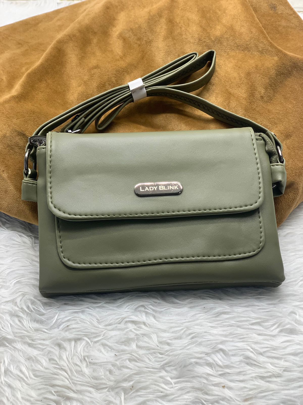 TRENDBUY olive green PU leather sling bag, highlighting secure zipper closure.